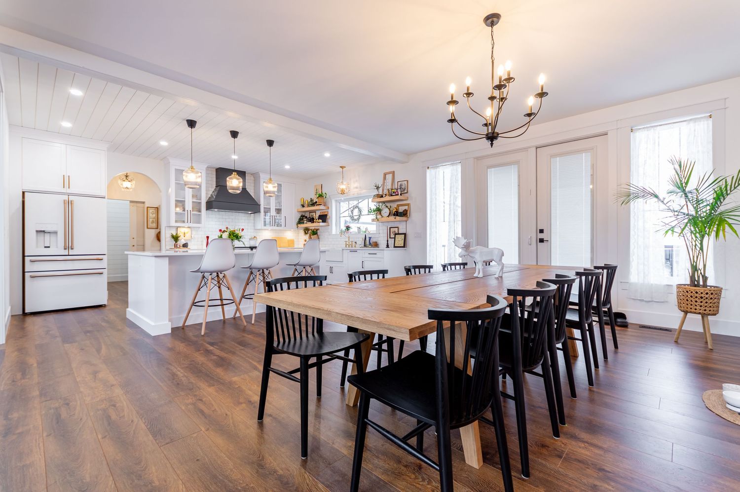 Spacious kitchen and dining area in a farmhouse style home Central Alberta Real Estate Media David Spence Photography HDR image white / gold