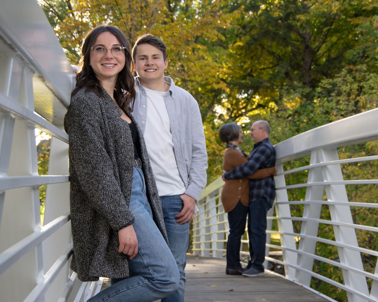 Central Alberta Real Estate Media David Spence Photography Family of 4 posed on a white bridge in a park