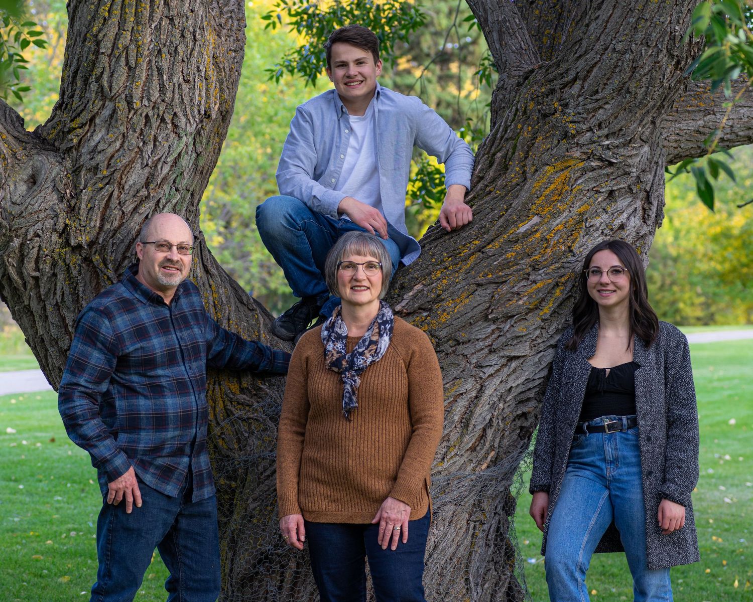 Central Alberta Real Estate Media David Spence Photography  Family of 4 posed near a tree in a Red Deer park