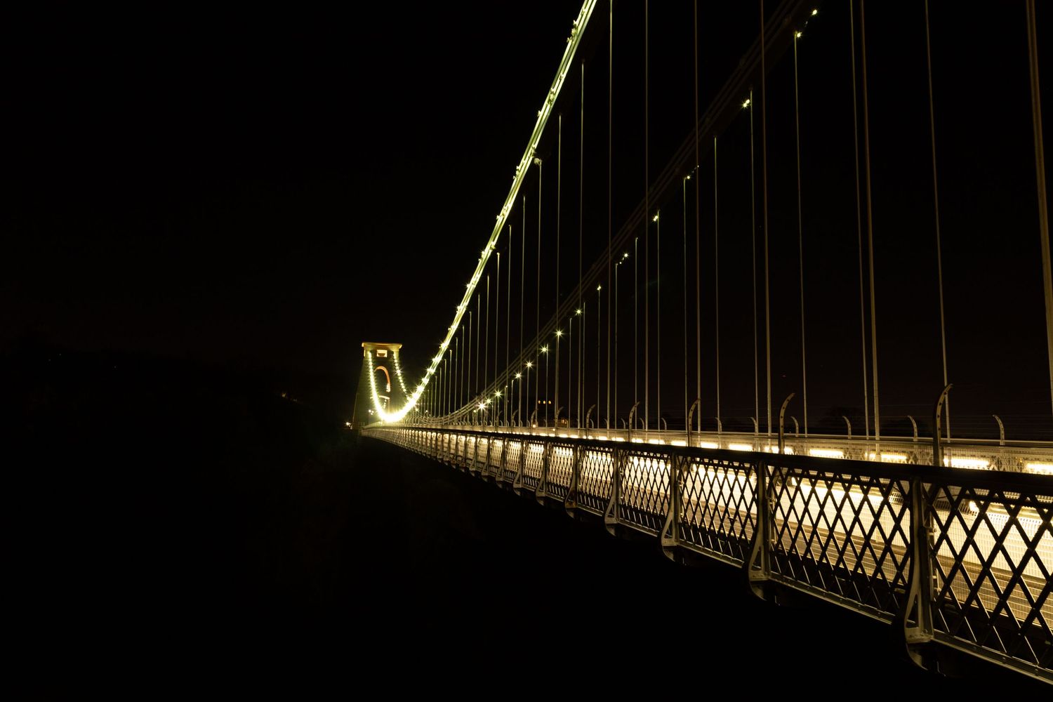 Clifton Suspension Bridge in Bristol illuminated at night, iconic city landmark.