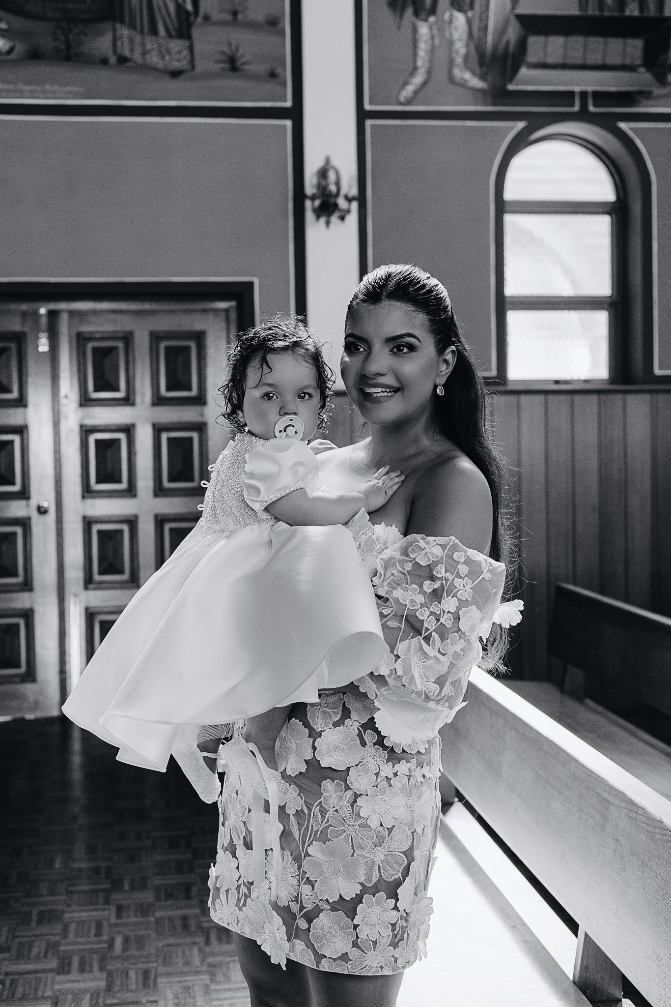 Joyful moment during christening ceremony inside traditional church setting.