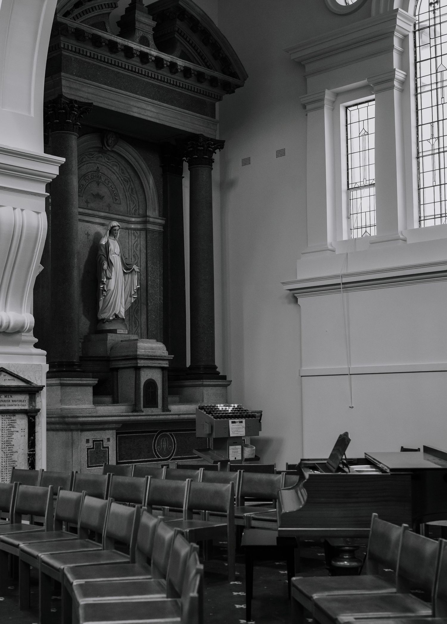 Interior of historic church with wooden pews and ornate architectural details.