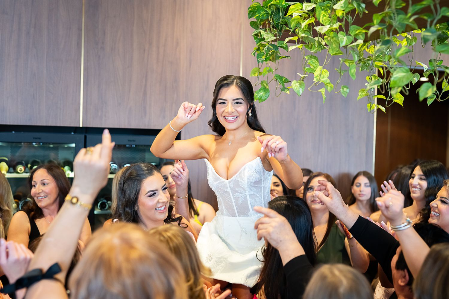 A joyous celebration scene at a wedding reception with guests cheering in a contemporary venue.