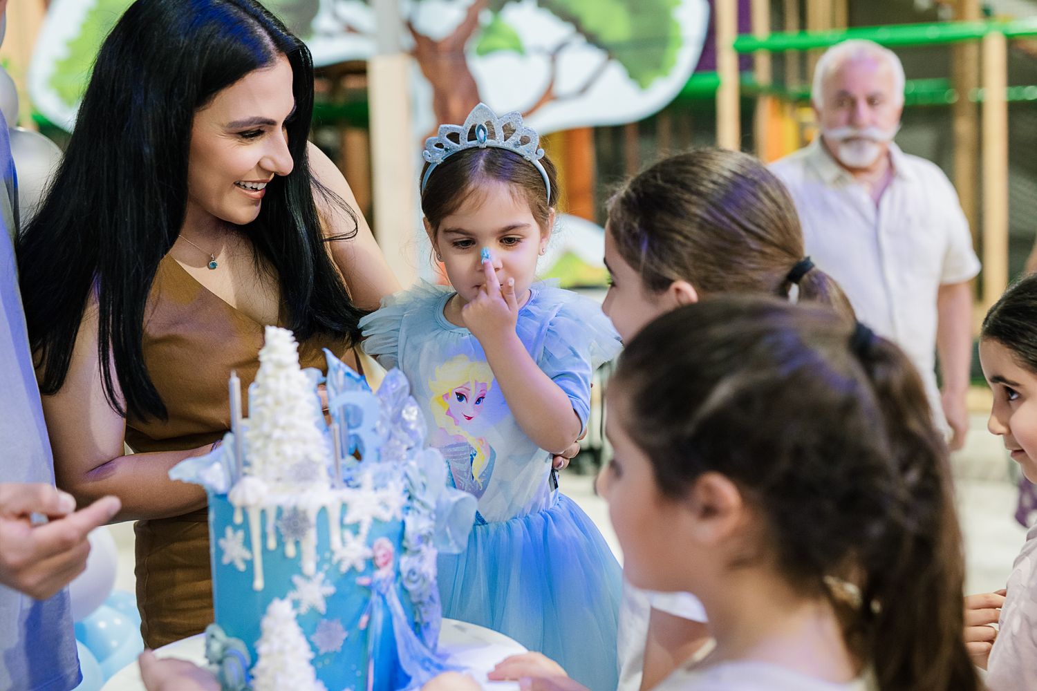 Birthday party scene with decorative blue and white winter theme elements.
