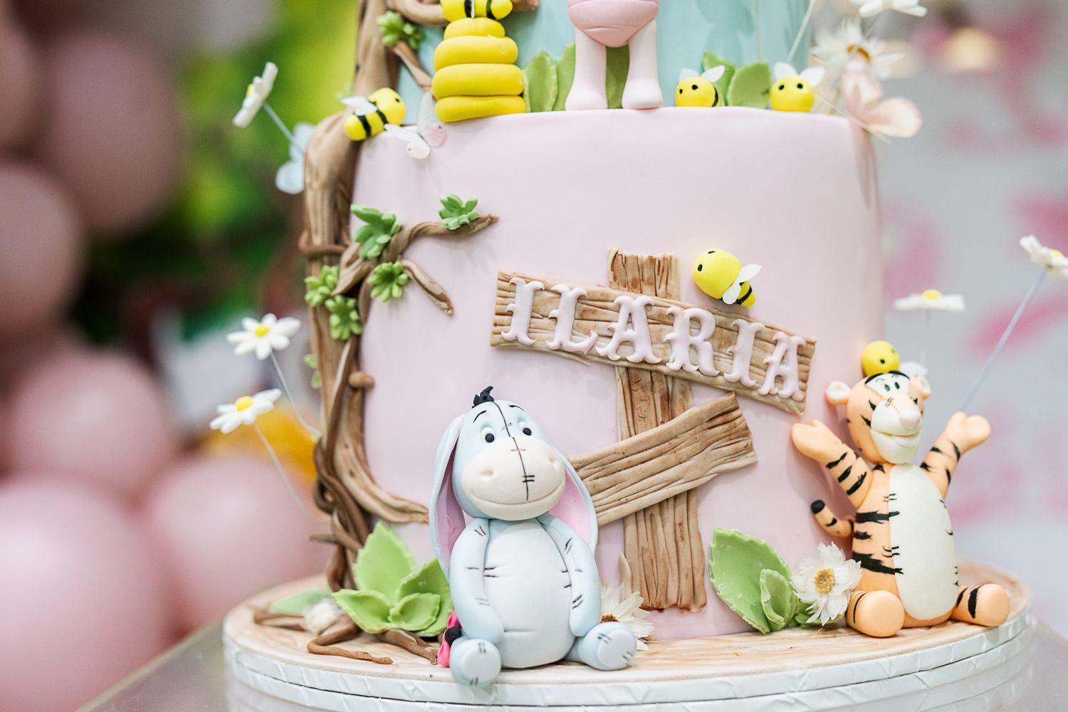 Adorable children's birthday cake decorated with cute stuffed animal characters and woodland theme details.