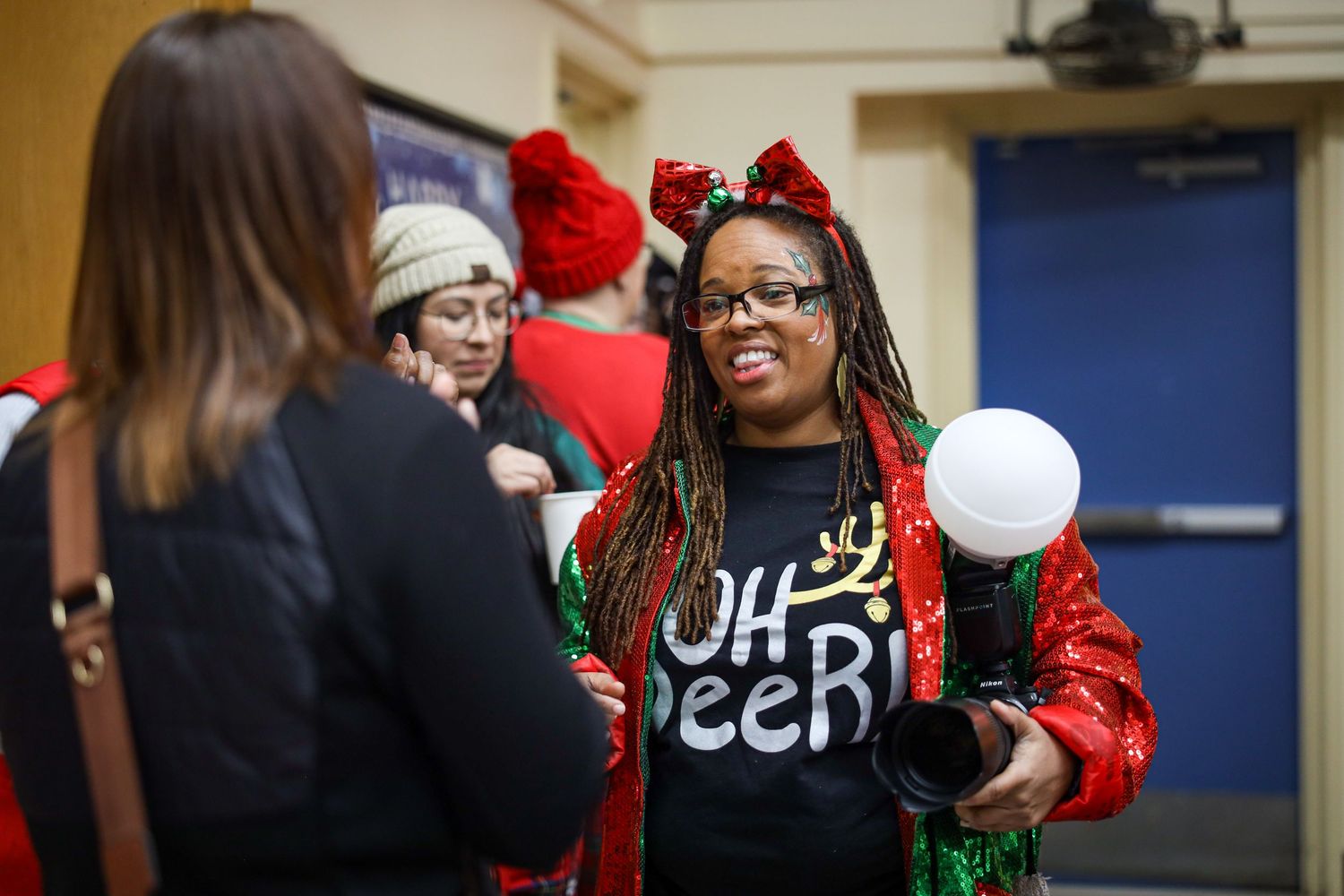 Students in red and black attire gather together in a school hallway for a special event.