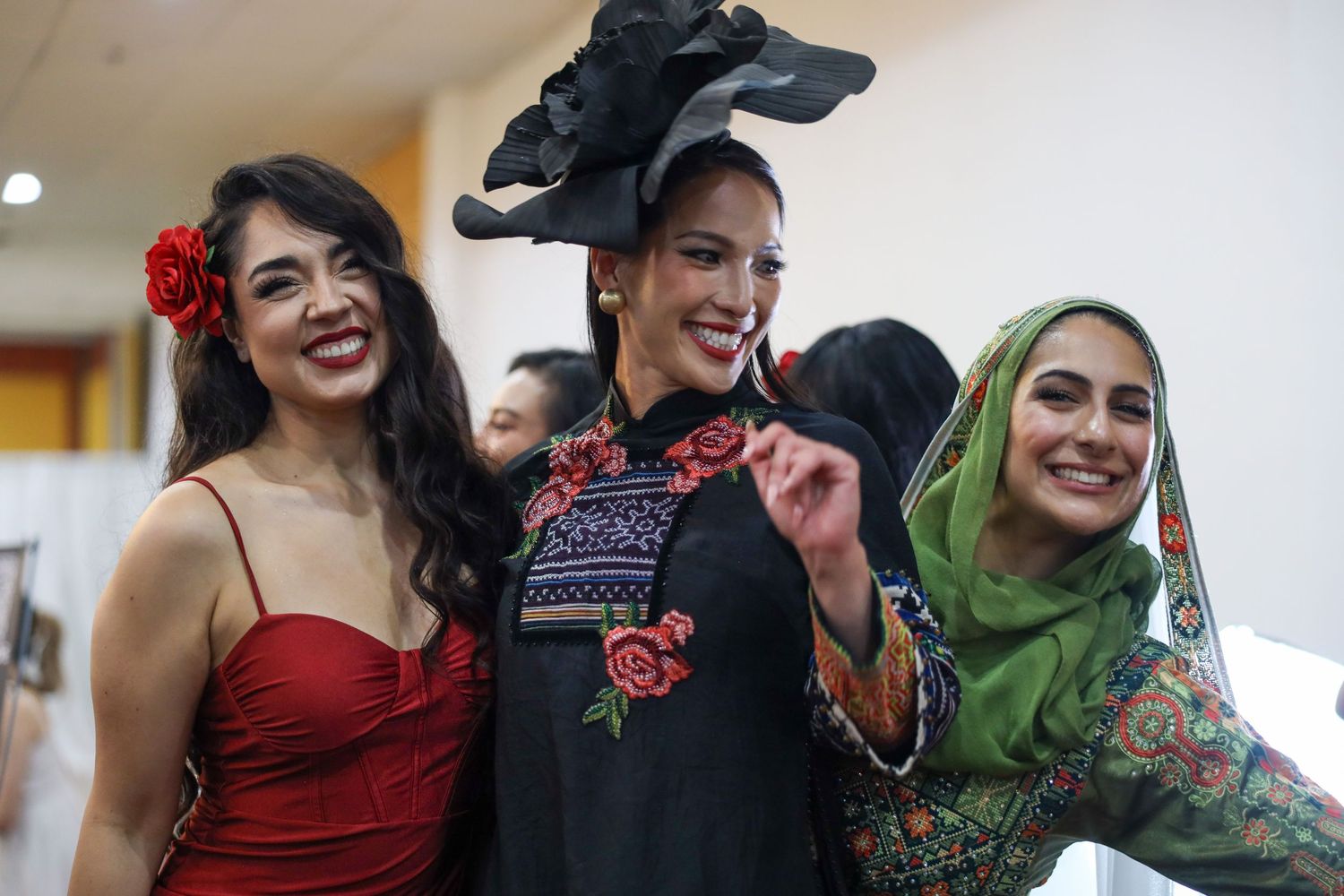 A group of friends laughing together during a social gathering with warm lighting and casual atmosphere.