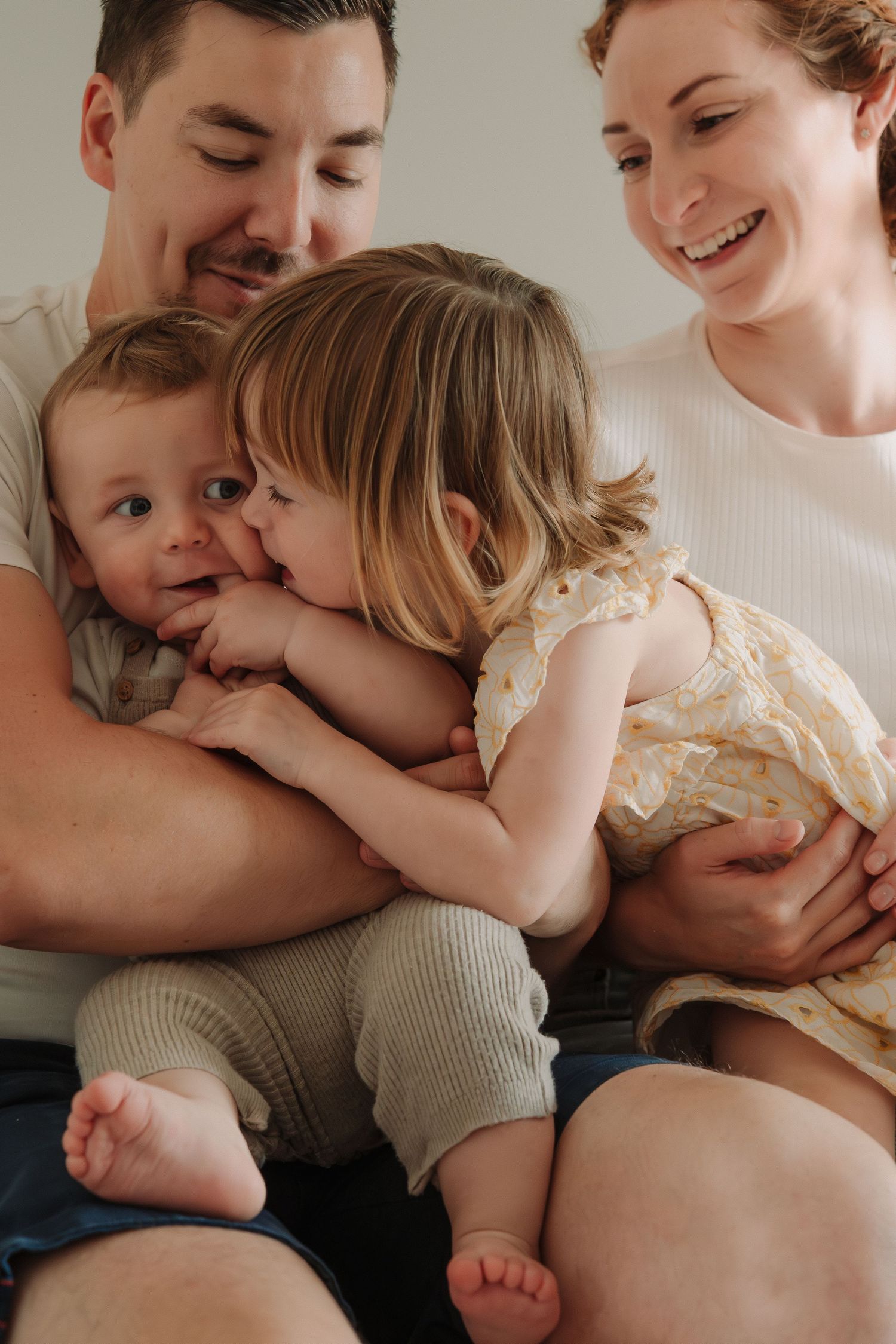 A loving family shares tender moments together in a series of intimate black and white photographs.