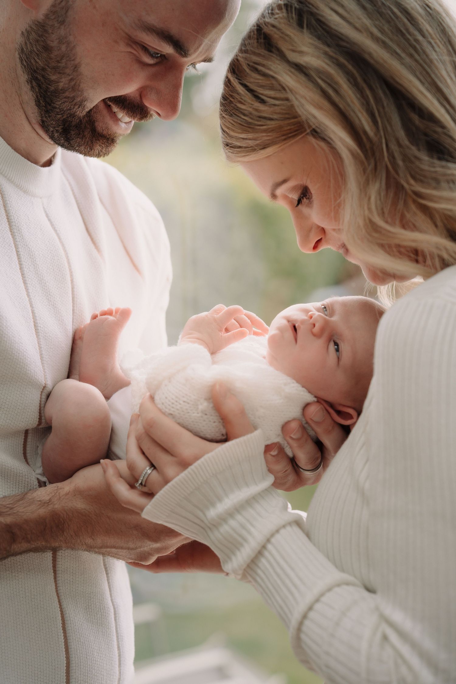 Sweet candid moments captured in white clothing against soft natural lighting.