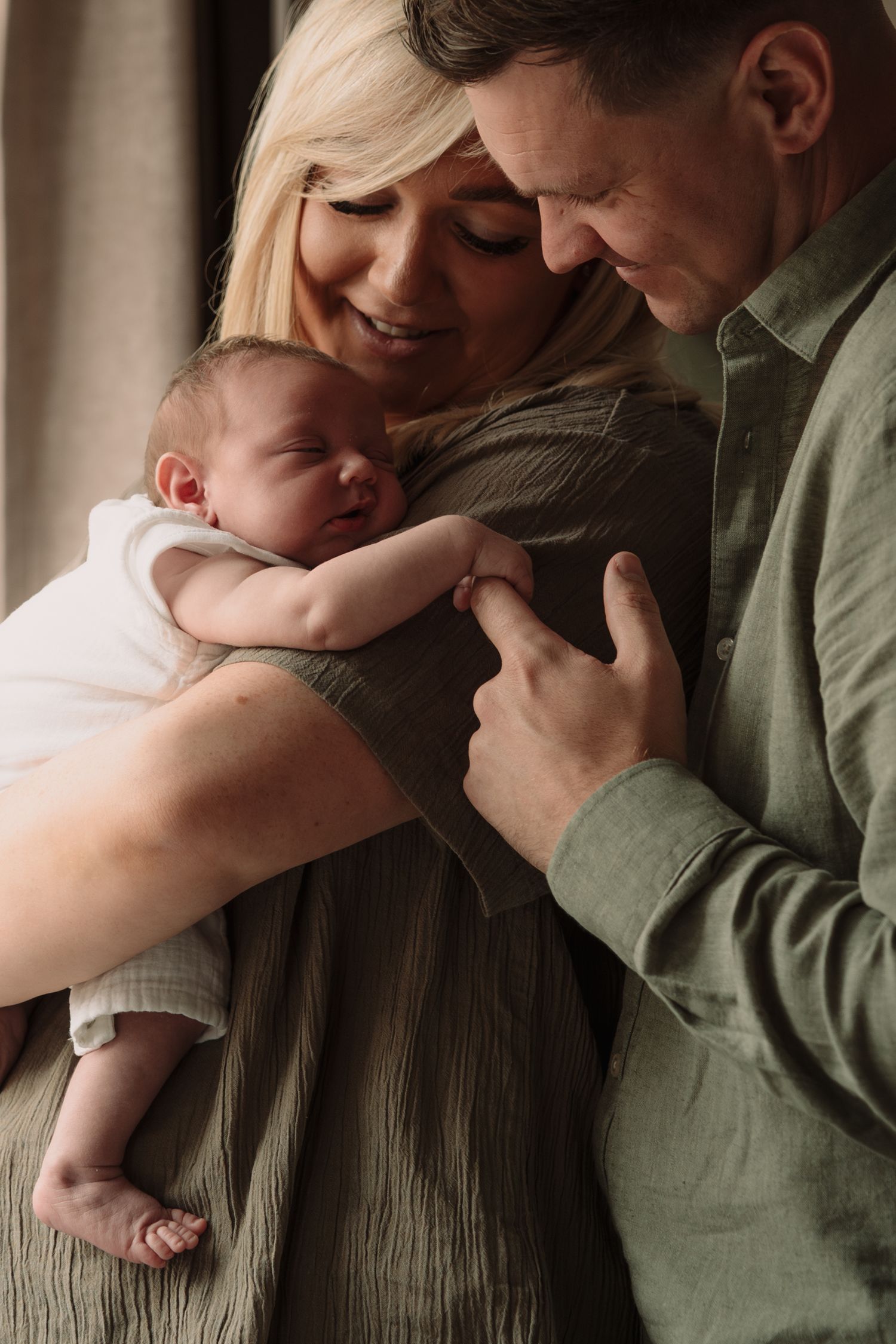 Emotional family embrace captured in sequence with soft natural lighting.