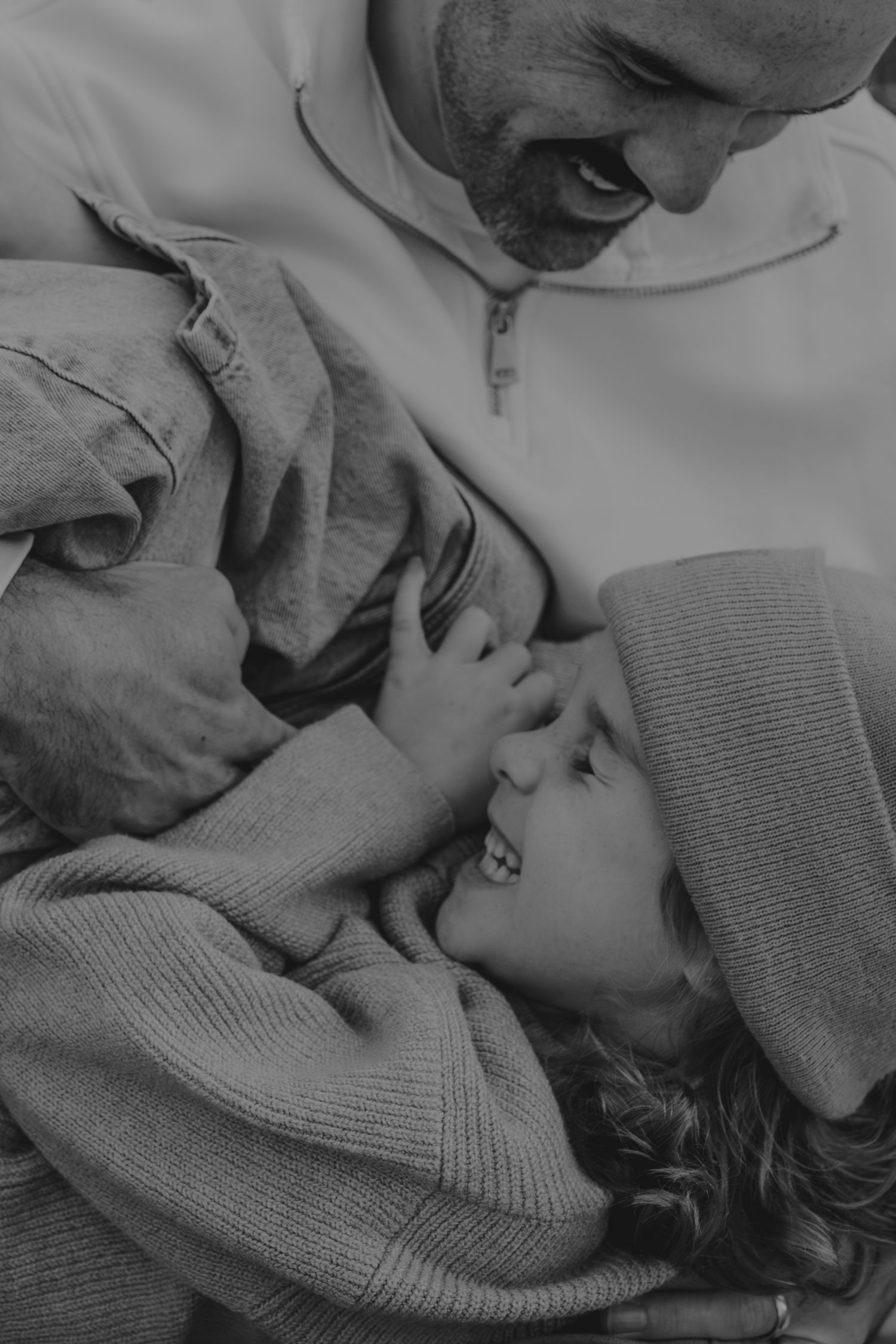 Black and white sequence showing intimate family bonding moments in soft focus.