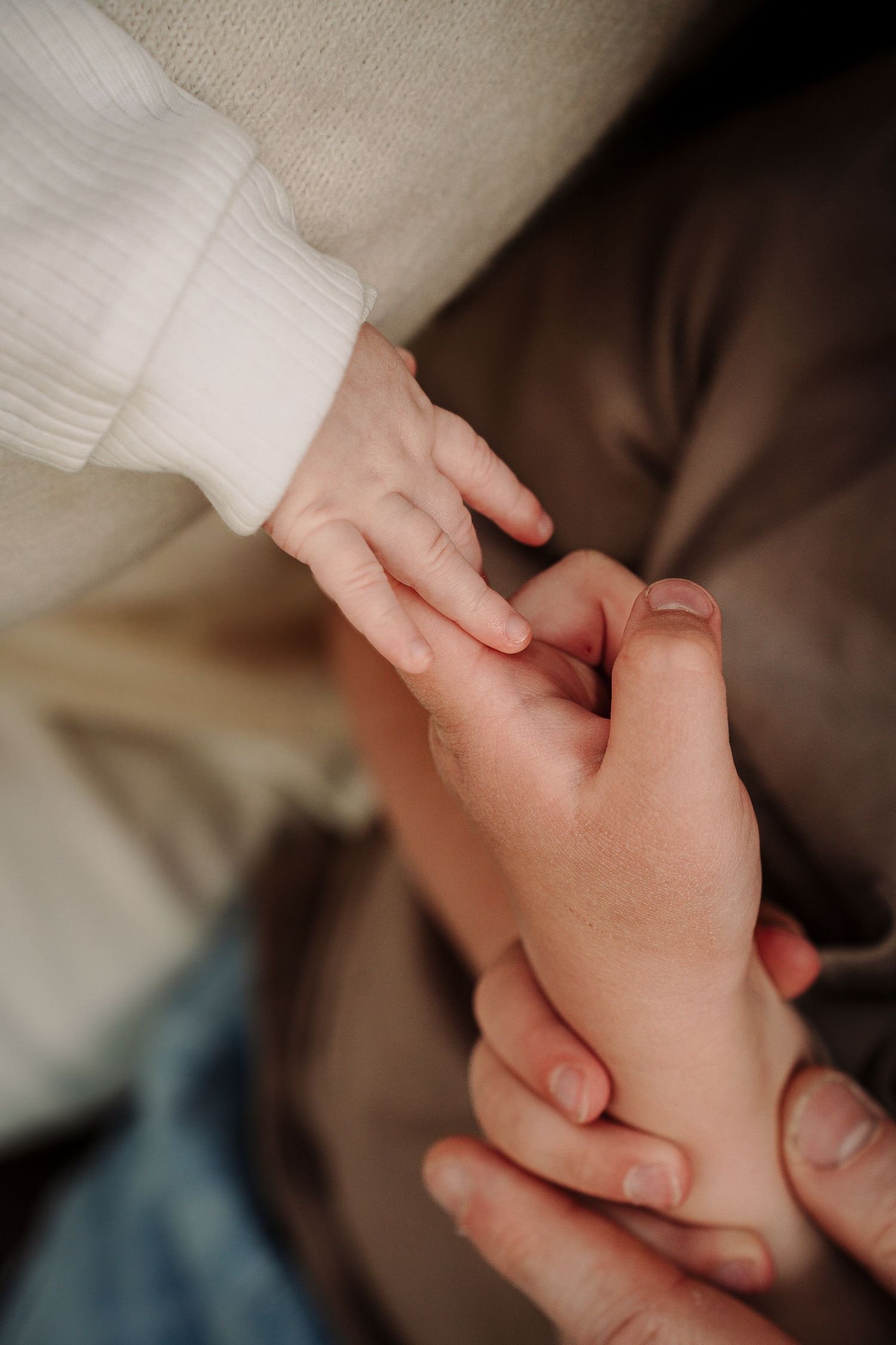 Close-up sequence of hands gently holding and intertwining in an intimate moment.