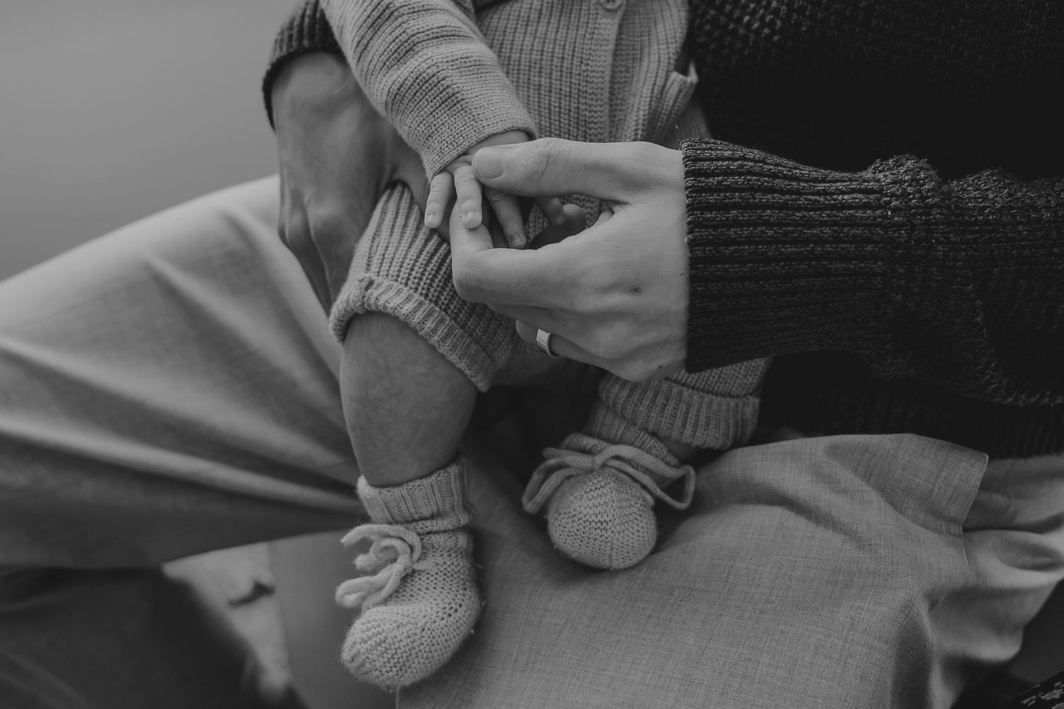 Black and white detail shots of tender moments between parent and child.