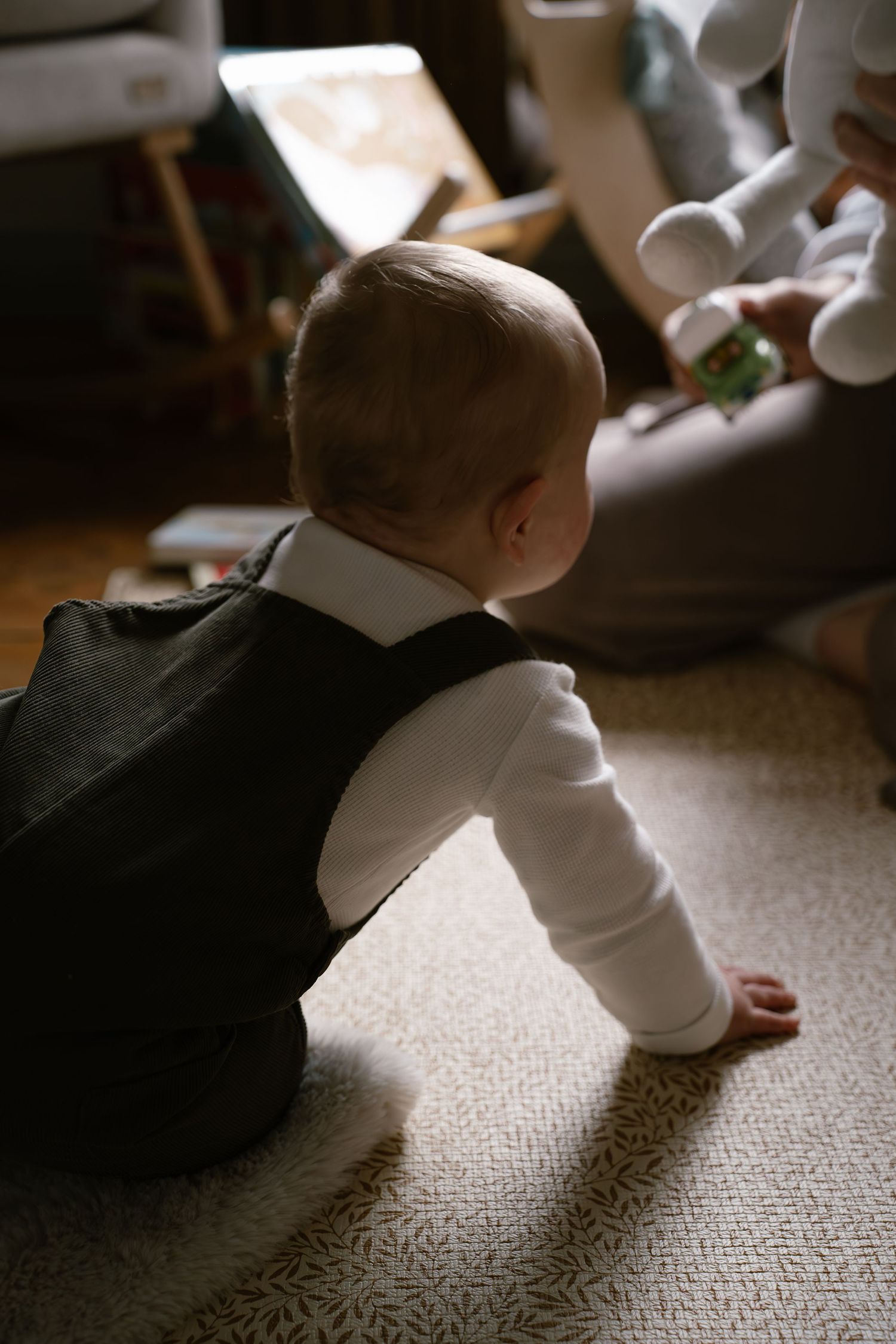 Close-up shots of a baby crawling on beige carpet, showing movement progression.