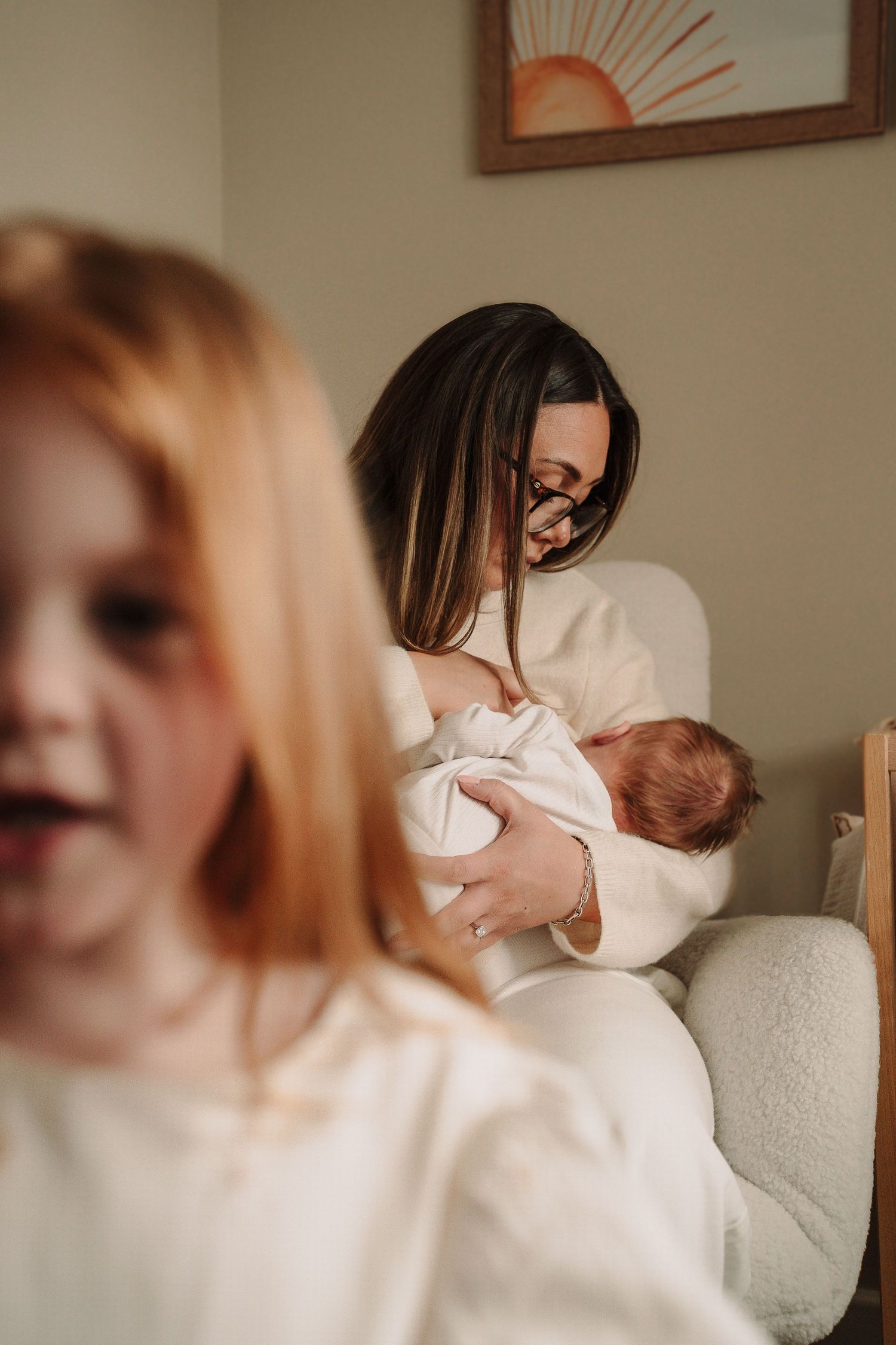 Series of candid indoor family photos showing gentle interaction in natural light.