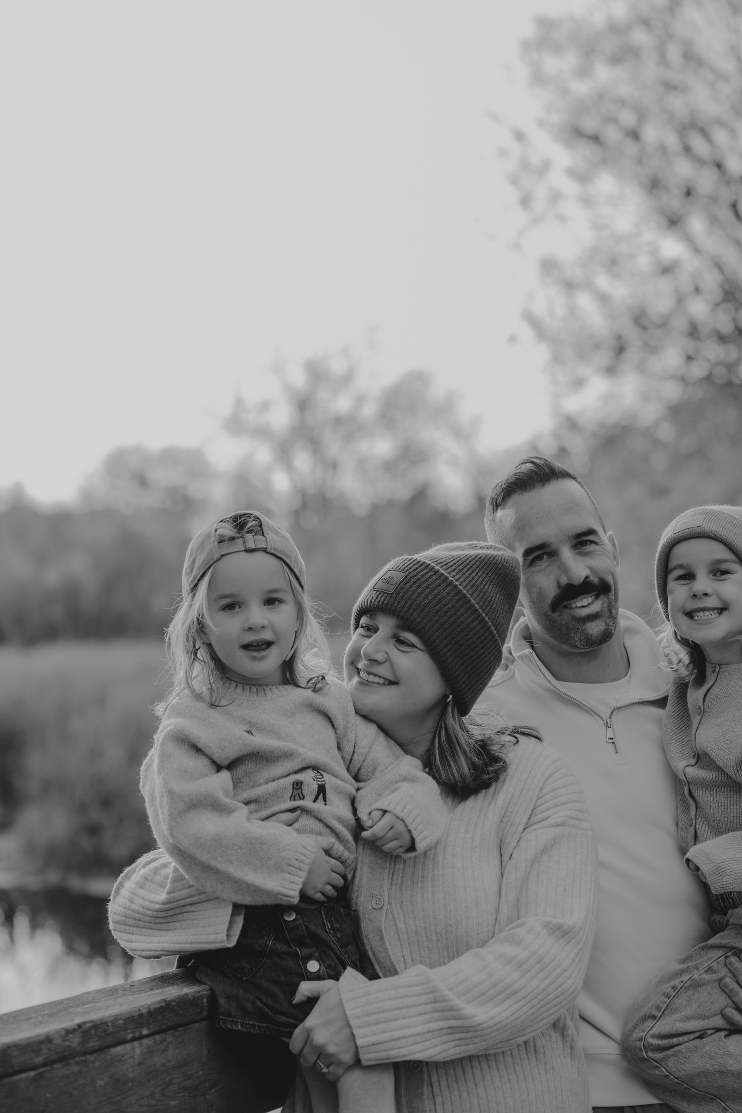 Black and white outdoor family portrait showing natural candid moments.