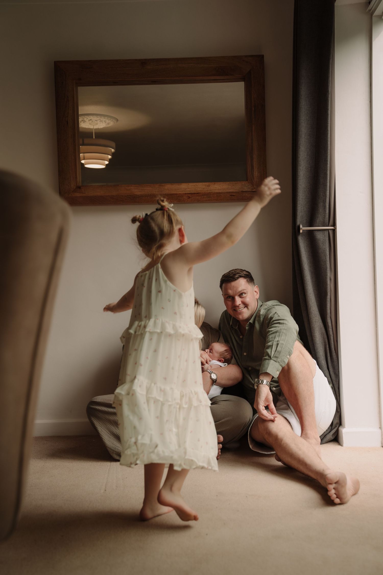 Creative indoor photography sequence showing playful moments under furniture.