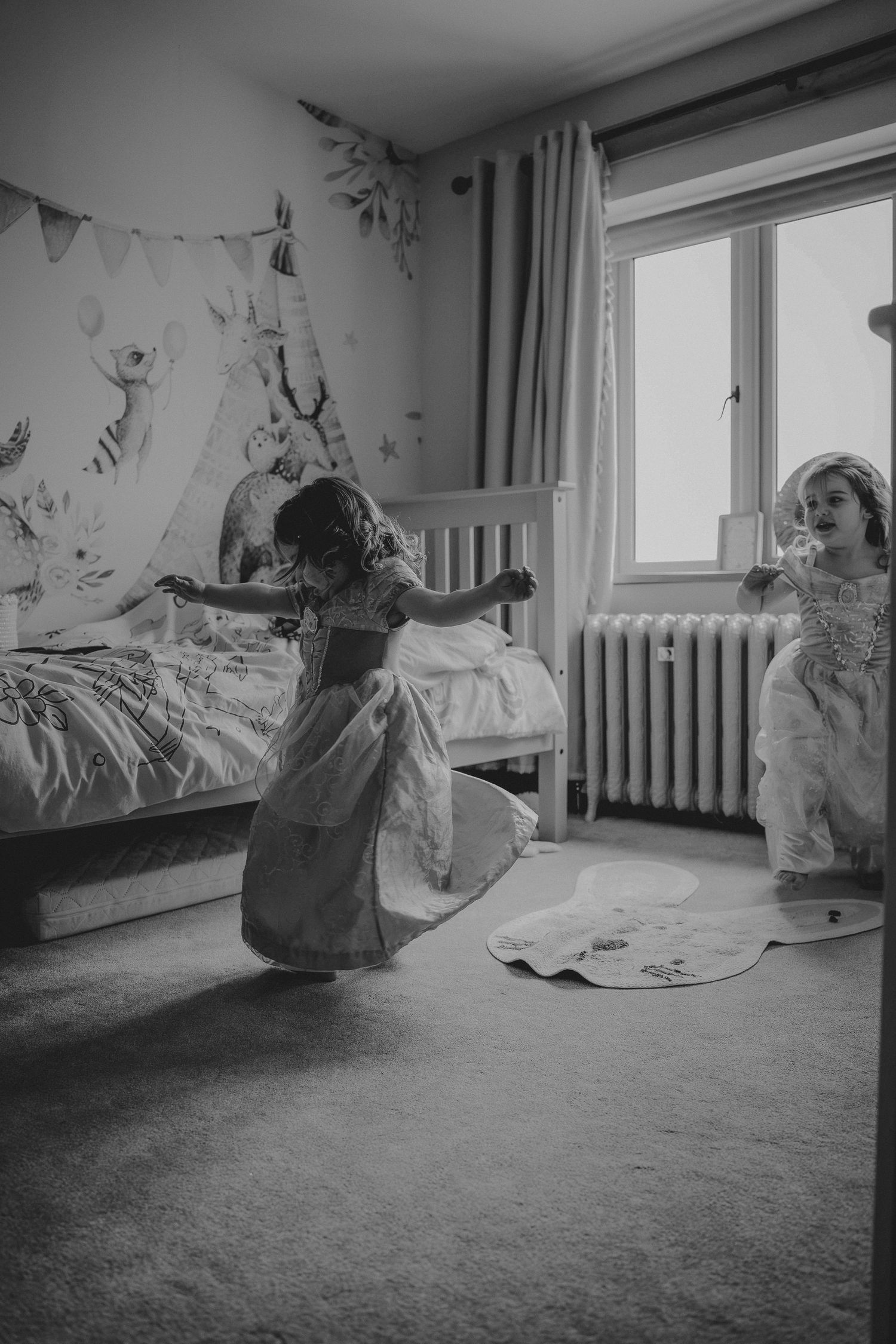 A sequence of black and white photos showing a figure in white clothing dancing and moving expressively across a room.