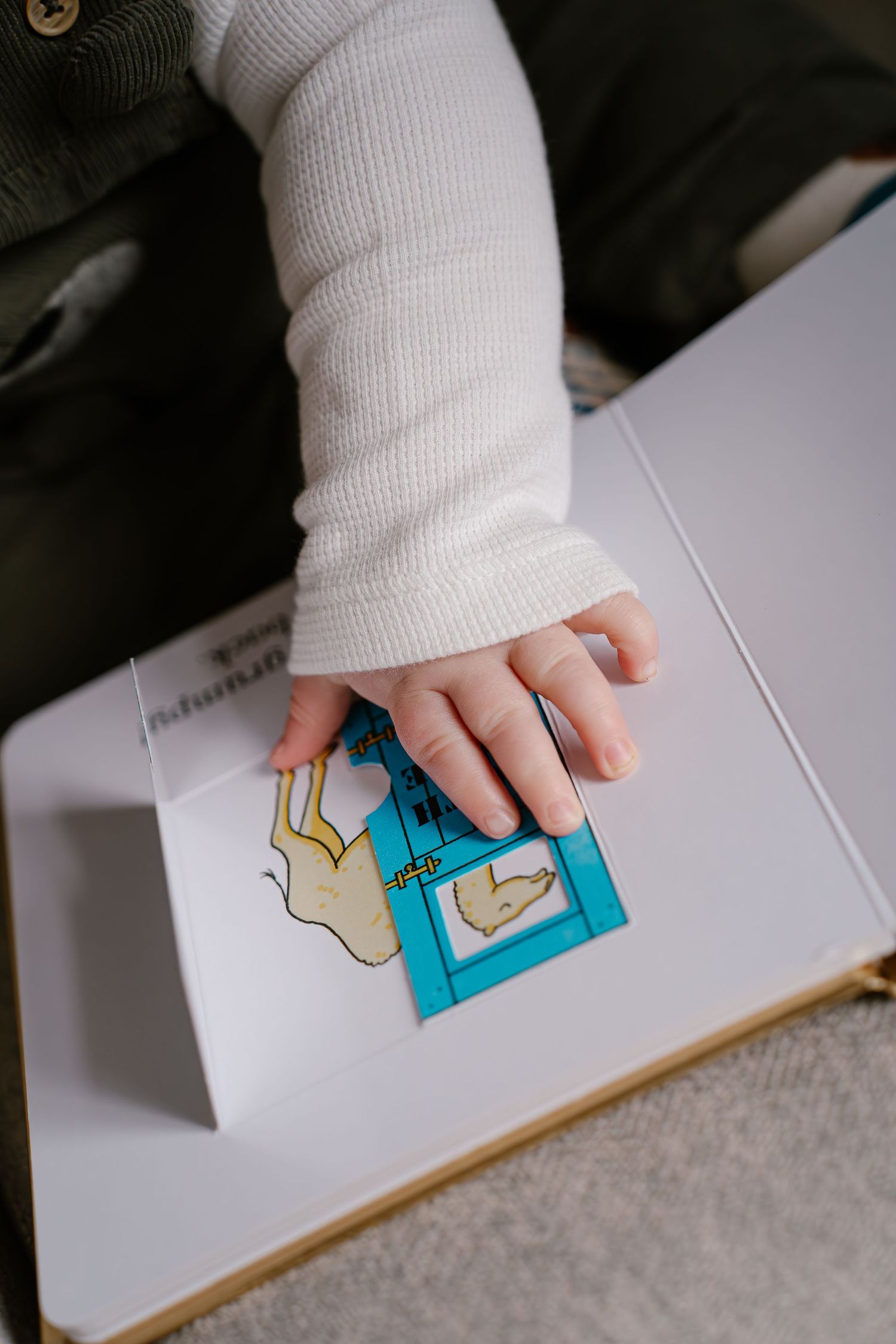 A small hand uses a blue rubber stamp to create an impression on white paper in a sequential photo series.