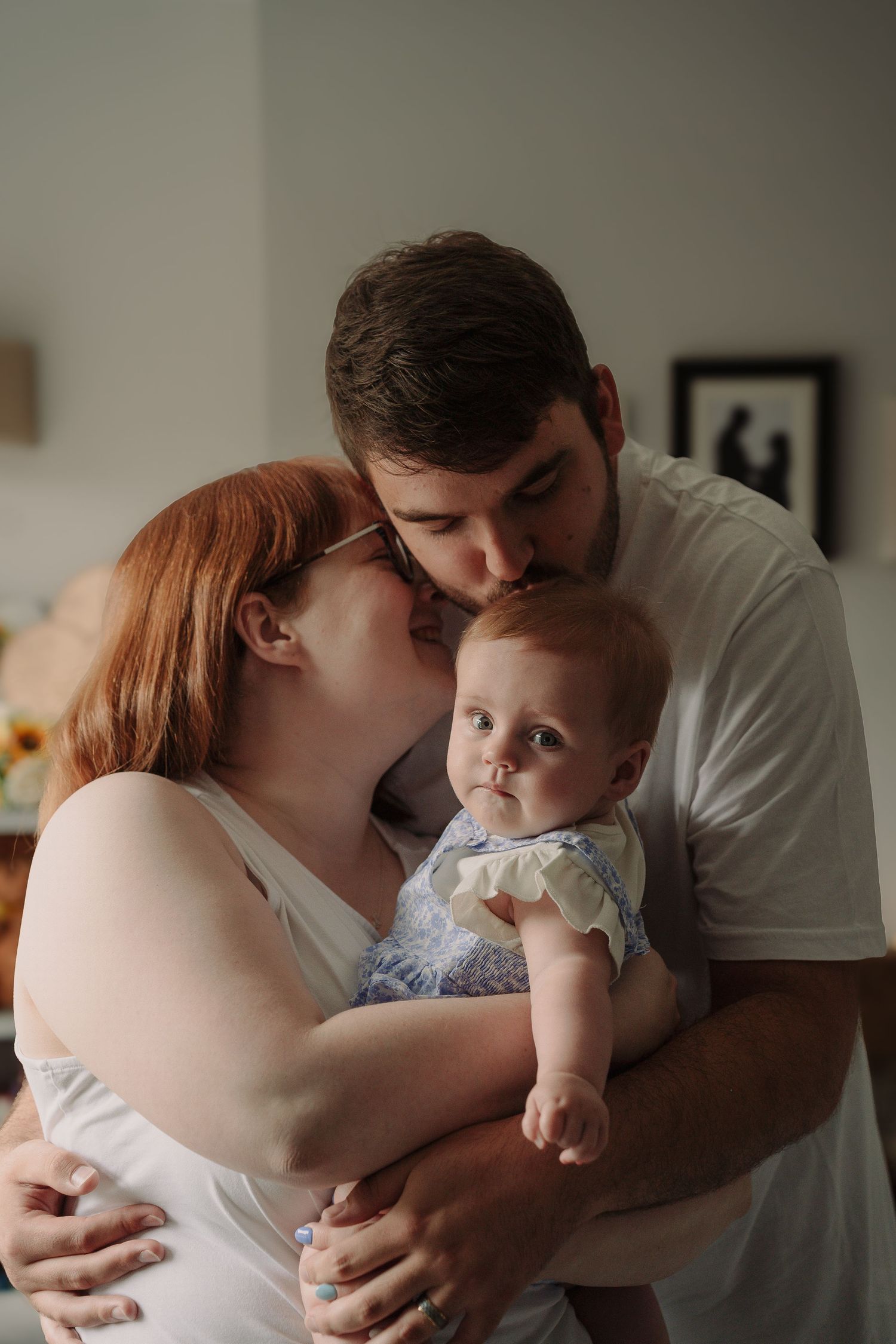 An intimate family portrait sharing a tender moment together.