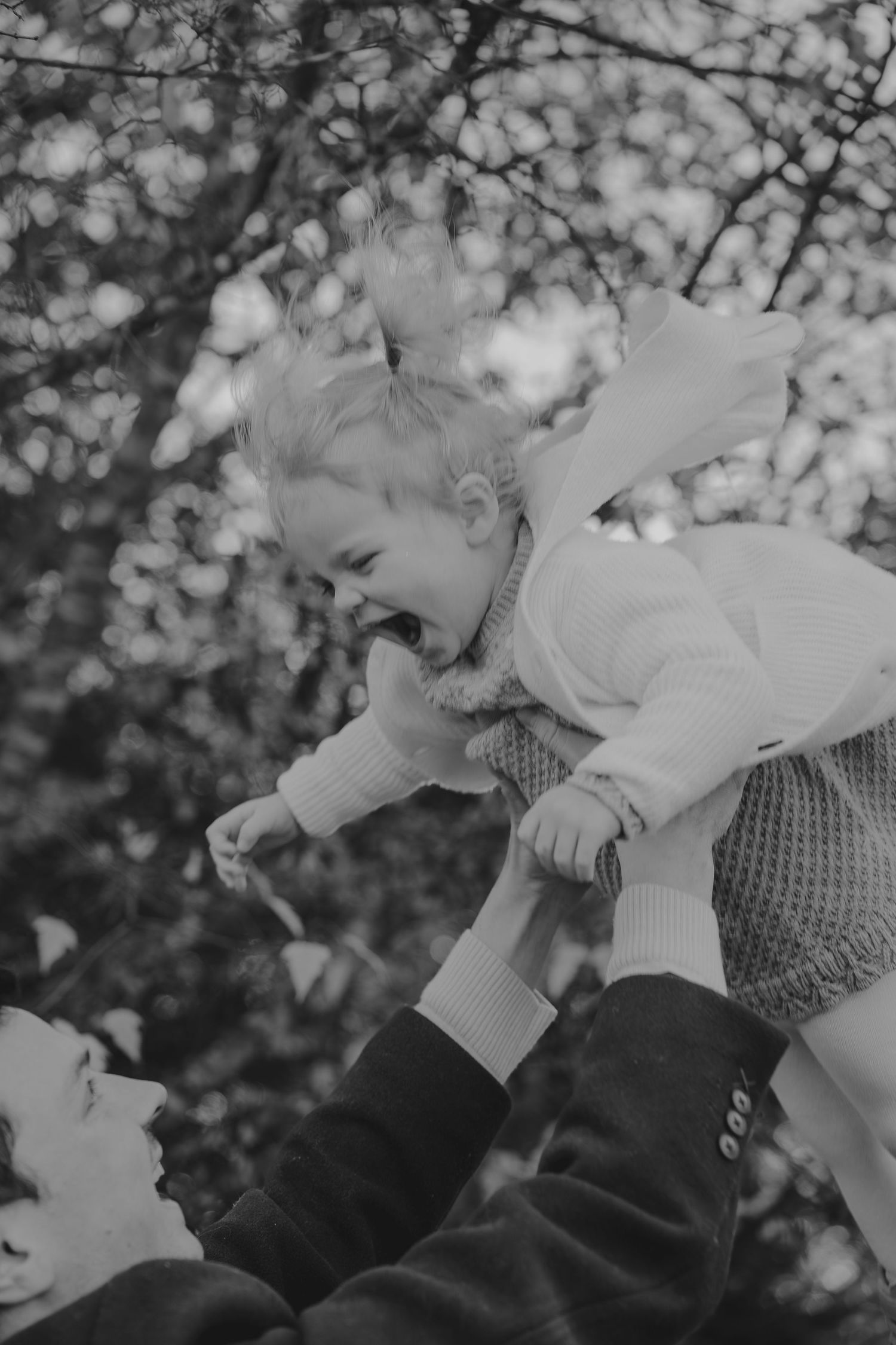 Black and white series showing gentle hand movements against a bokeh background.