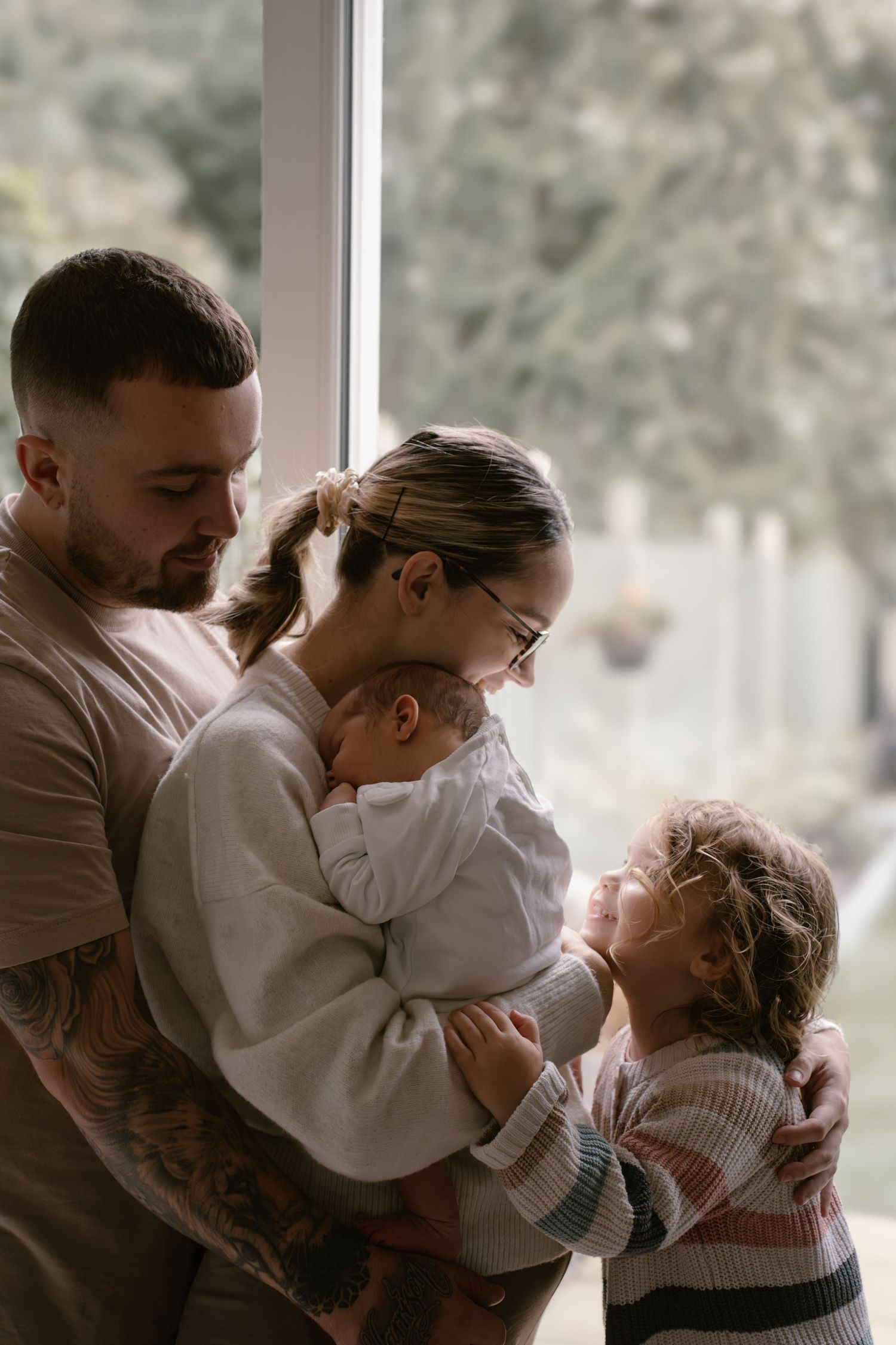 A series of intimate family moments showing tender embraces and affection in soft natural lighting.