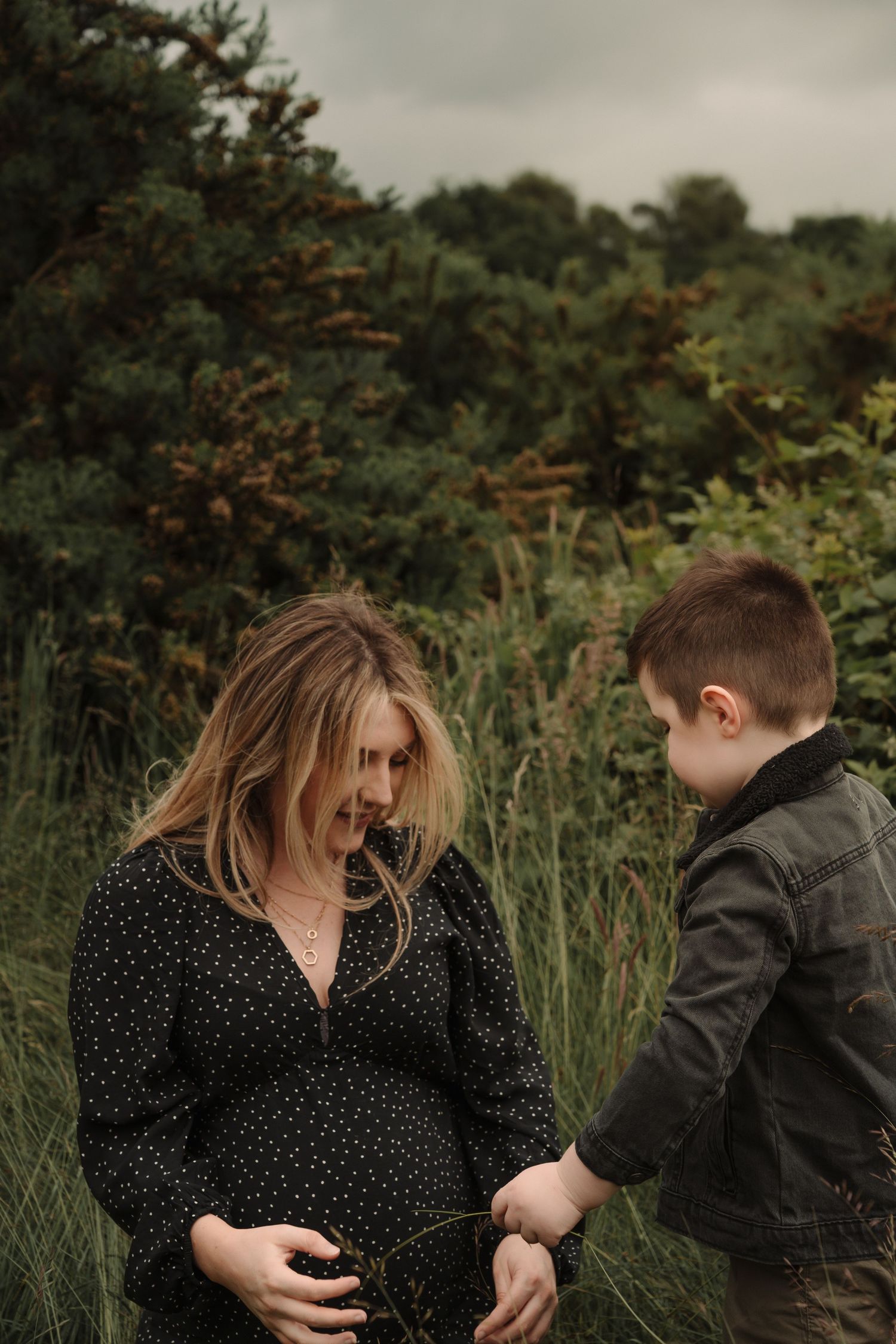 A joyful moment shared between people laughing together in a lush green outdoor setting.