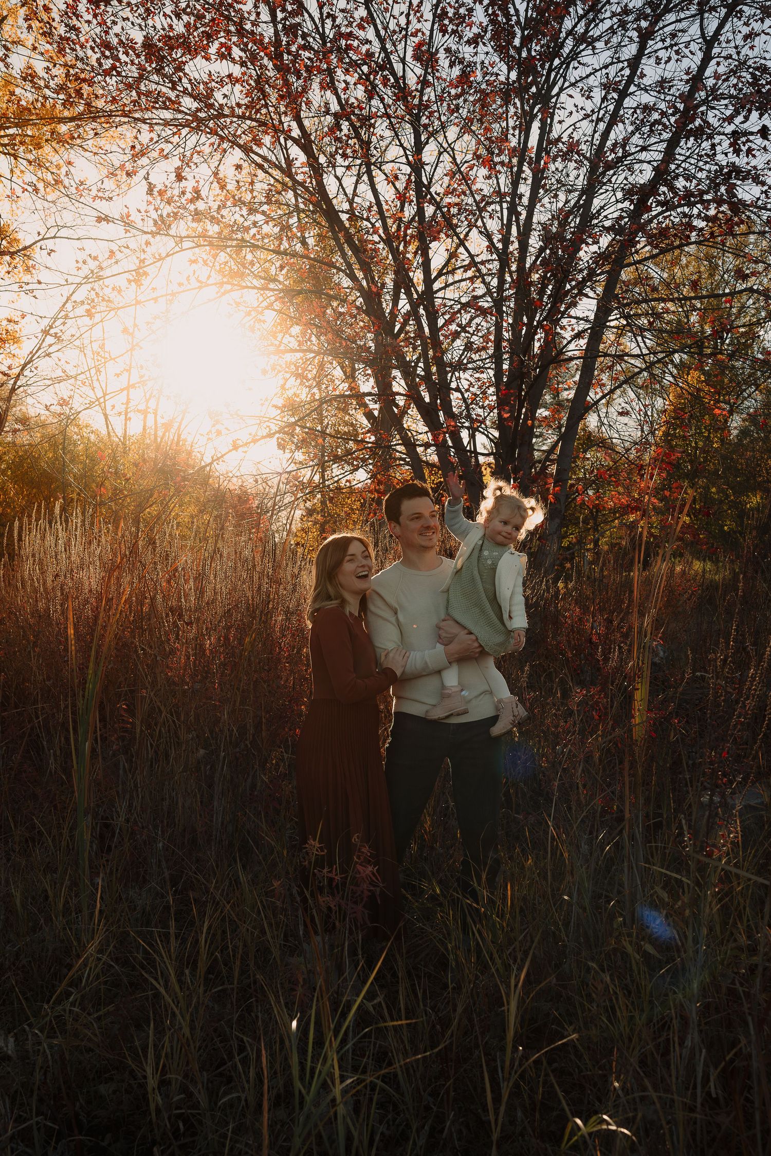 Family photoshoot in nature during golden hour with fall foliage.