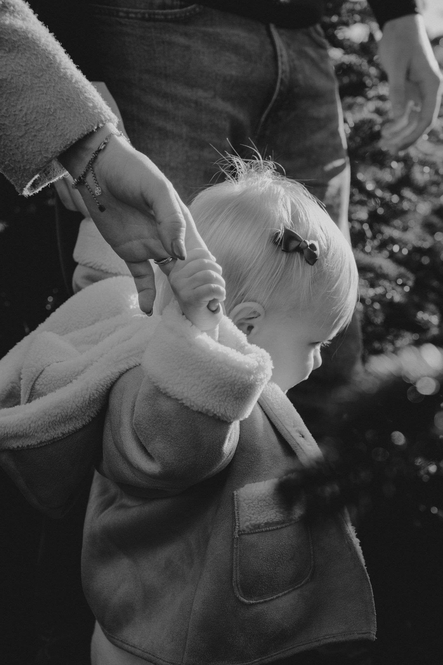 Black and white sequence showing gentle moments between parent and child outdoors.