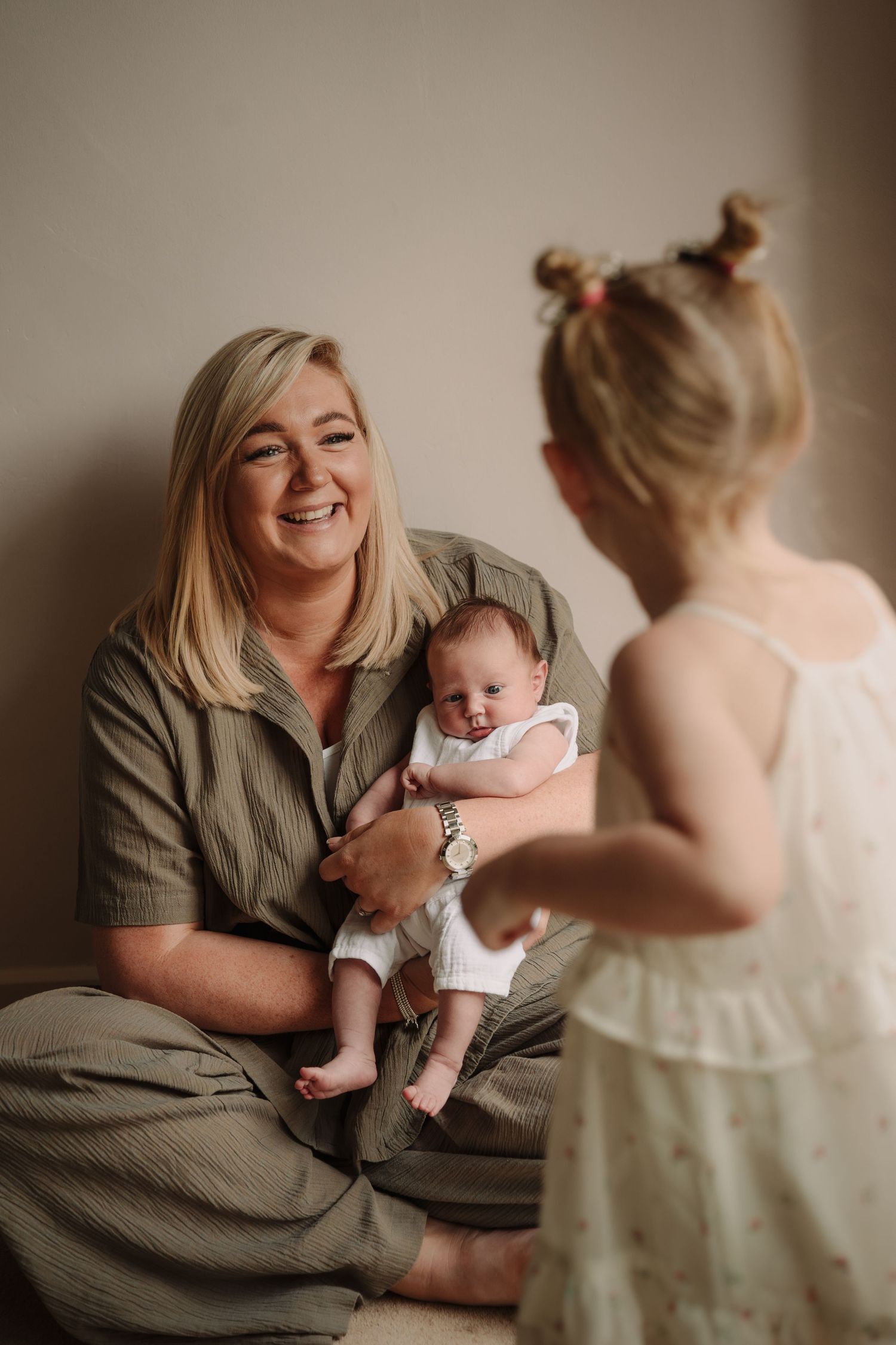 Natural lifestyle photography session showing candid family interactions indoors.