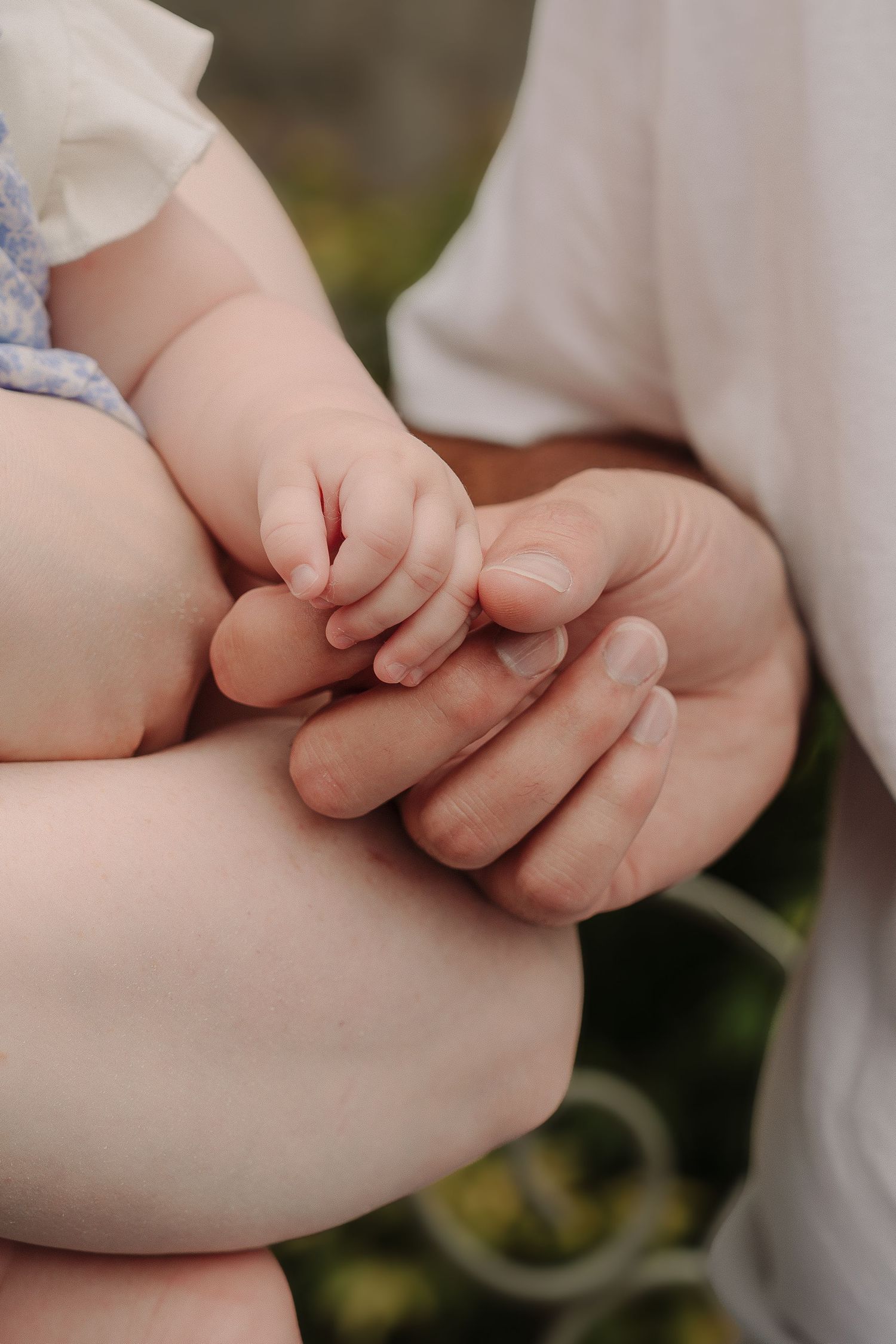 Close-up shots of tiny baby hands grasping adult fingers in intimate detail.