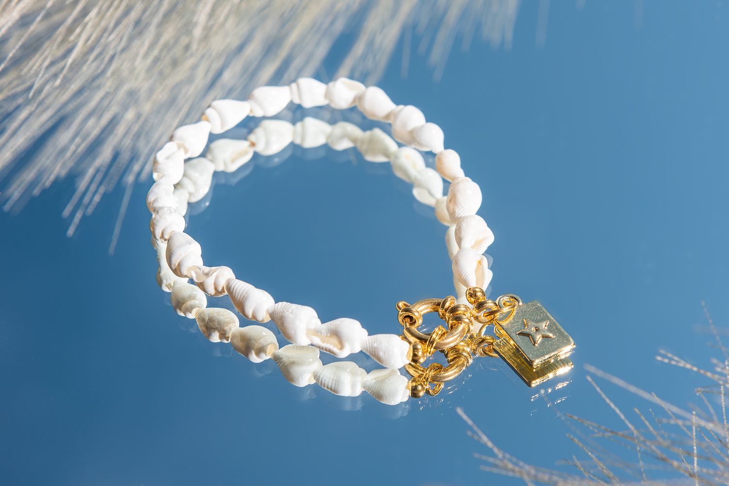 A white smoke ring floats against a bright blue sky with sunlight creating a glowing halo effect.