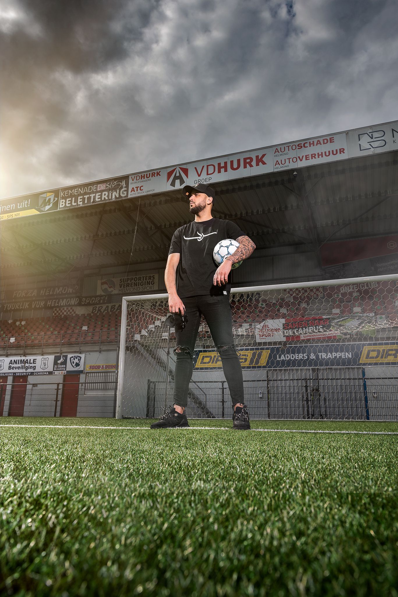 Dramatic sequence of soccer goalkeeper diving to save a ball against cloudy sky at stadium.