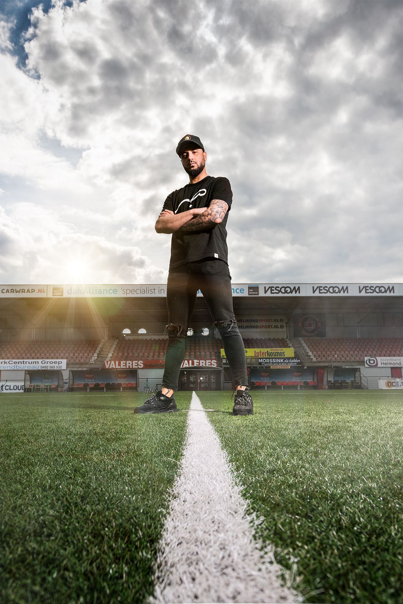 Dramatic panoramic sequence of a soccer field with white line markings under moody cloudy skies at sunset.