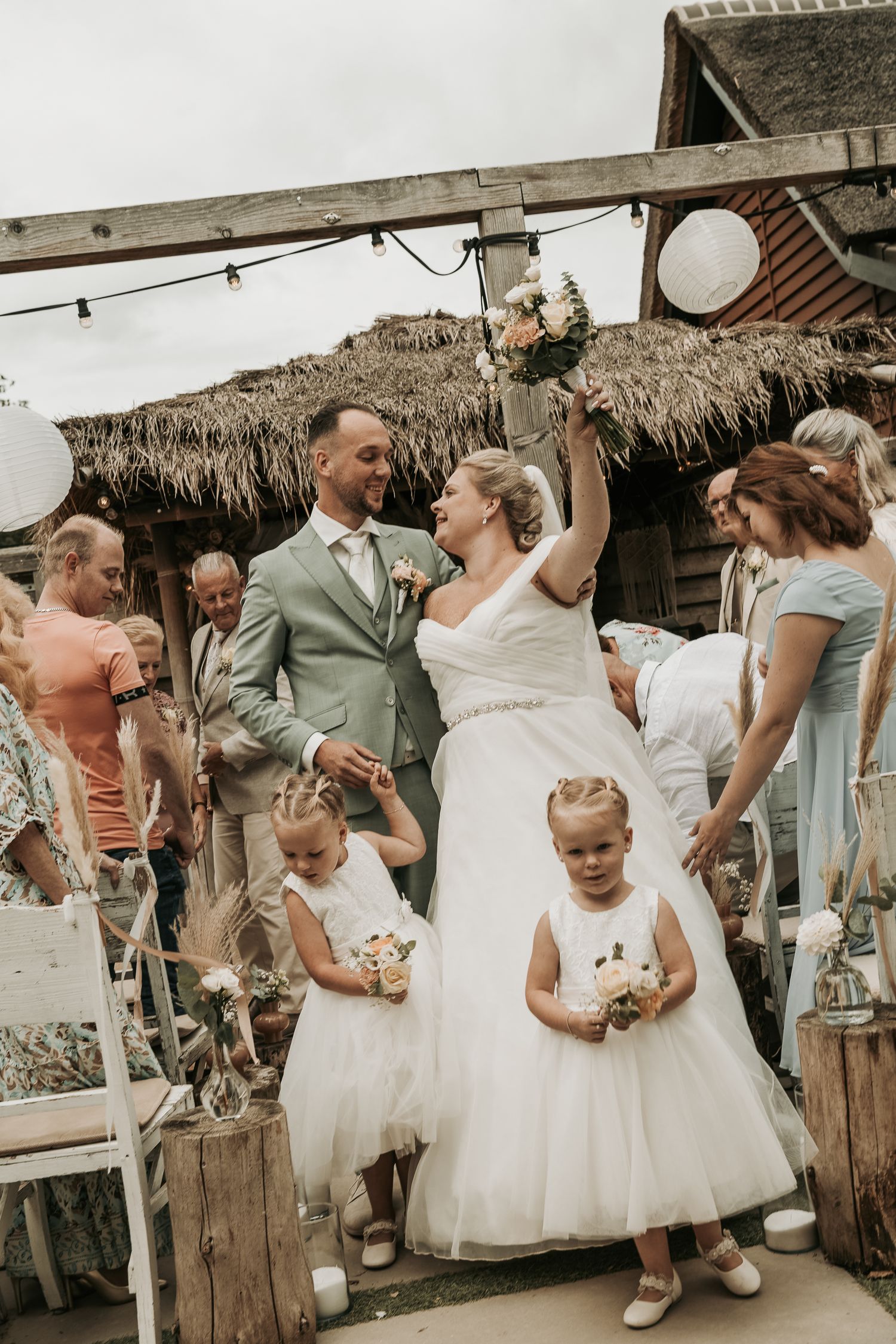 A joyful wedding celebration sequence showing dancing and embracing moments at a rustic outdoor venue.