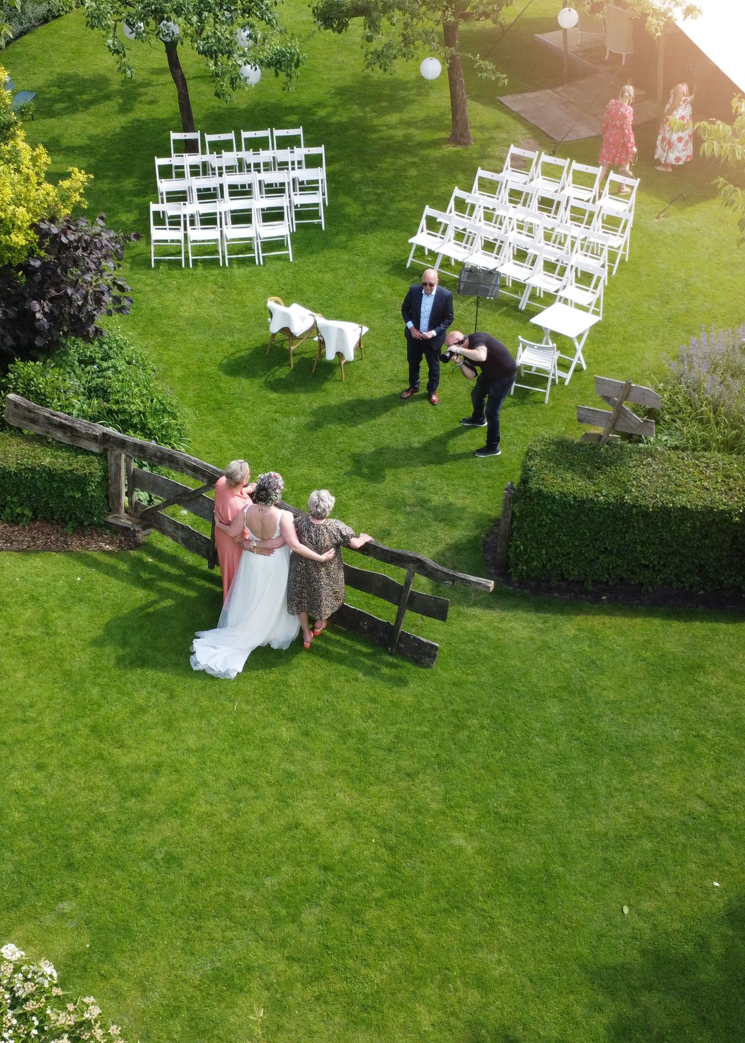 Wedding venue setup with white chairs on a green lawn and couple in elegant attire doing a photo shoot across multiple shots.