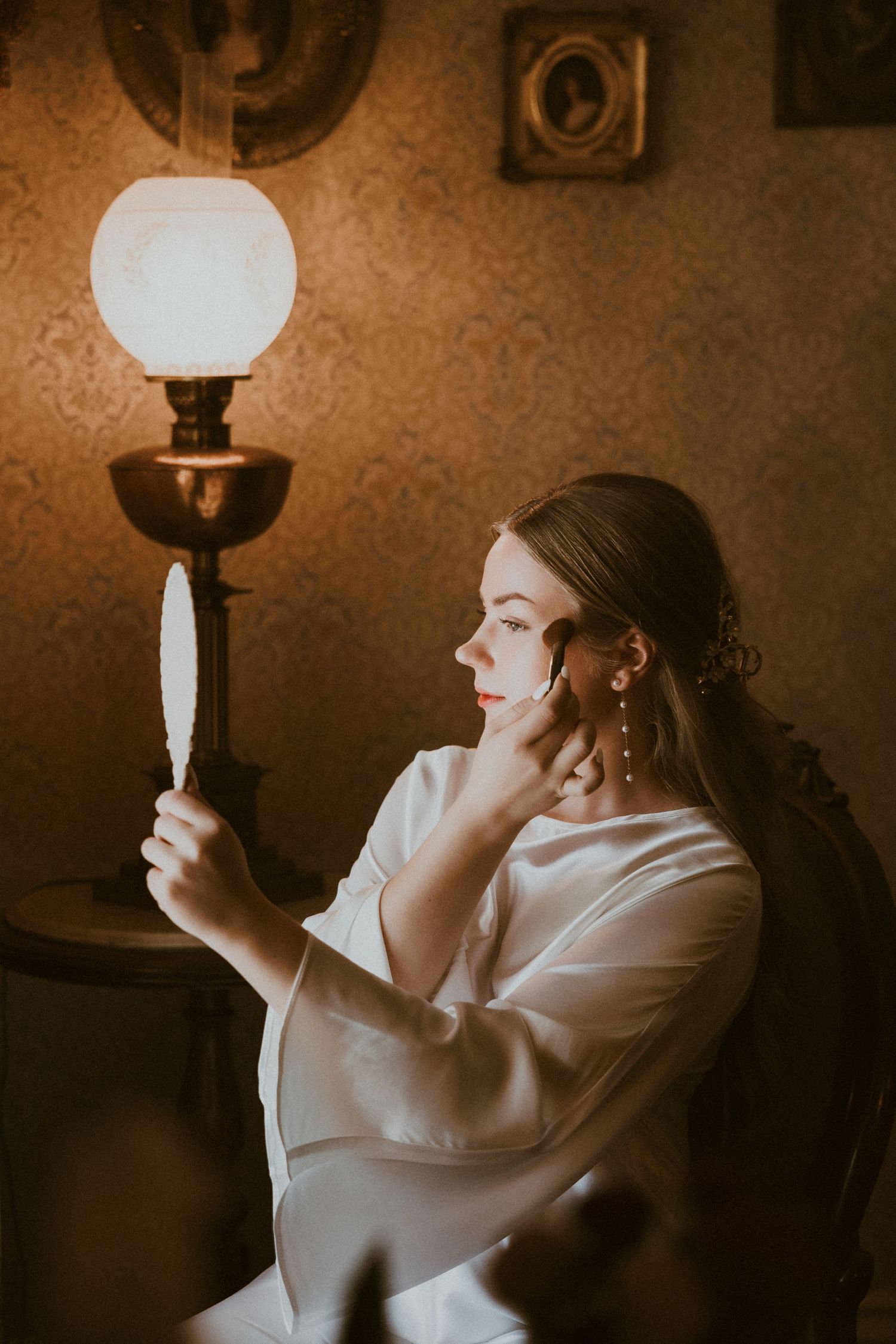 Moody boudoir photography with vintage-style lighting and warm sepia tones.