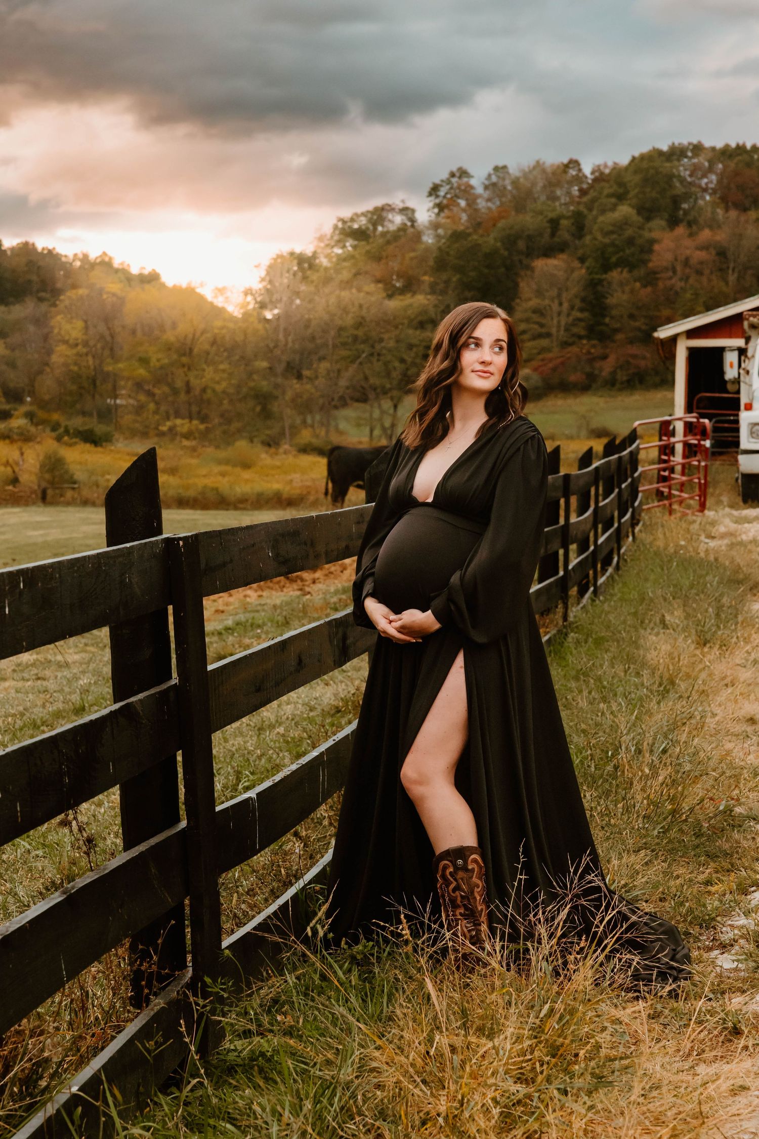 Maternity portrait session at sunset by rustic wooden fence.