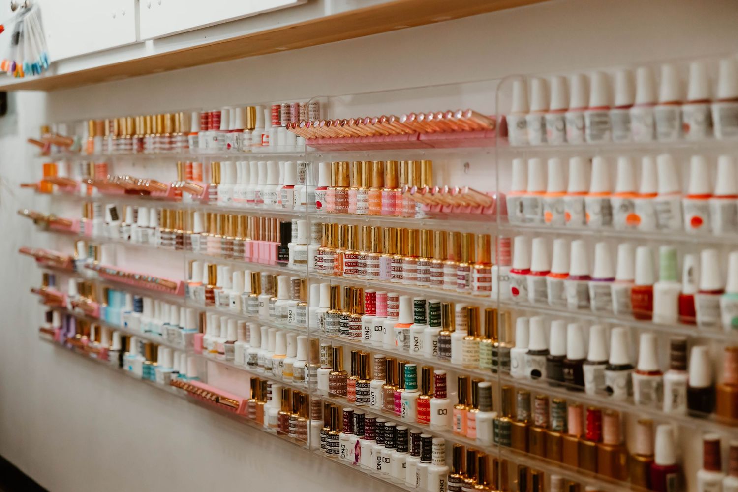 Salon product display shelves with organized rows of colorful bottles and beauty supplies.