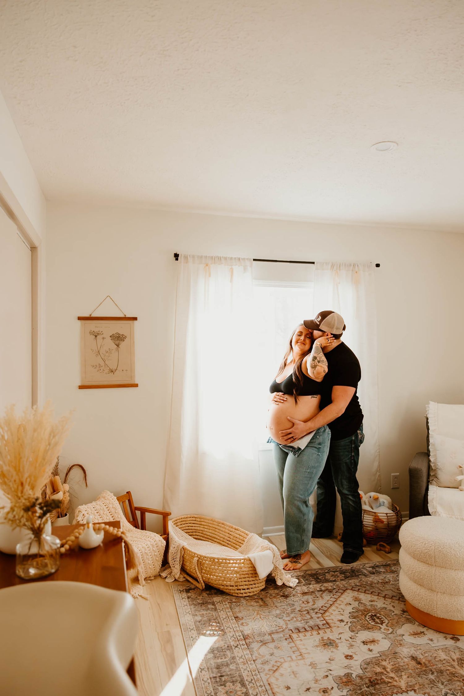 Warm-toned maternity photoshoot in cozy living room setting.