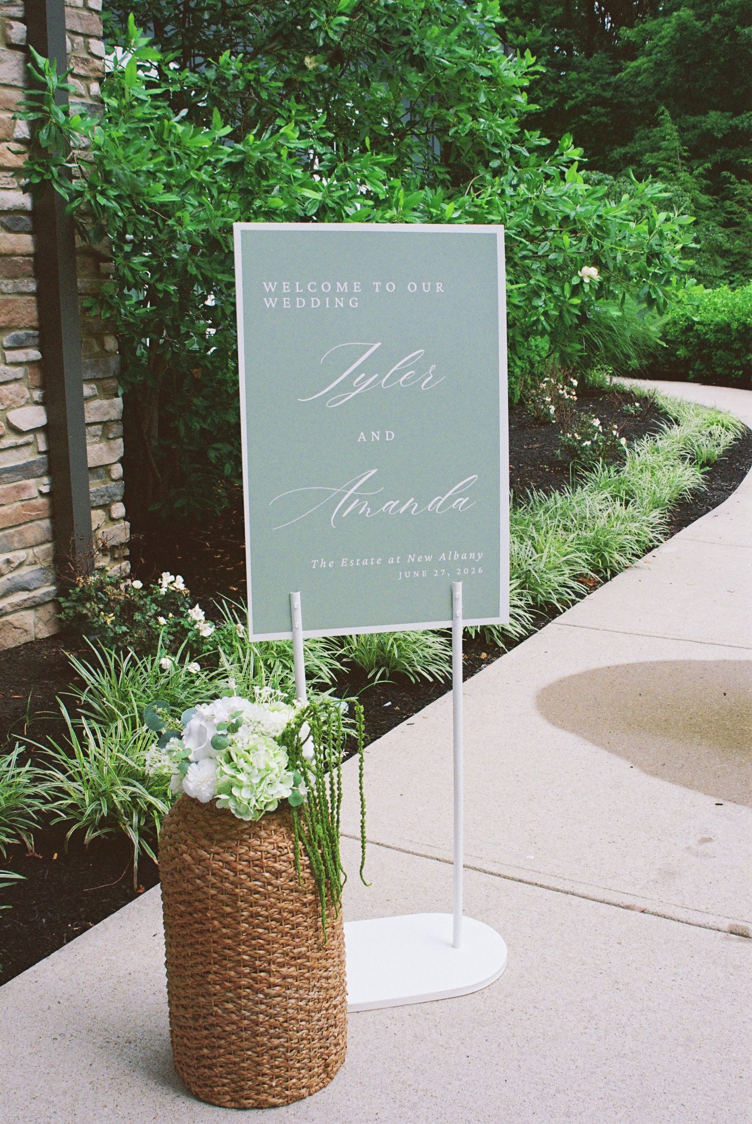 Wedding welcome sign for Tyler and Amanda at The Estate of New Albany displayed with hydrangea floral arrangement.