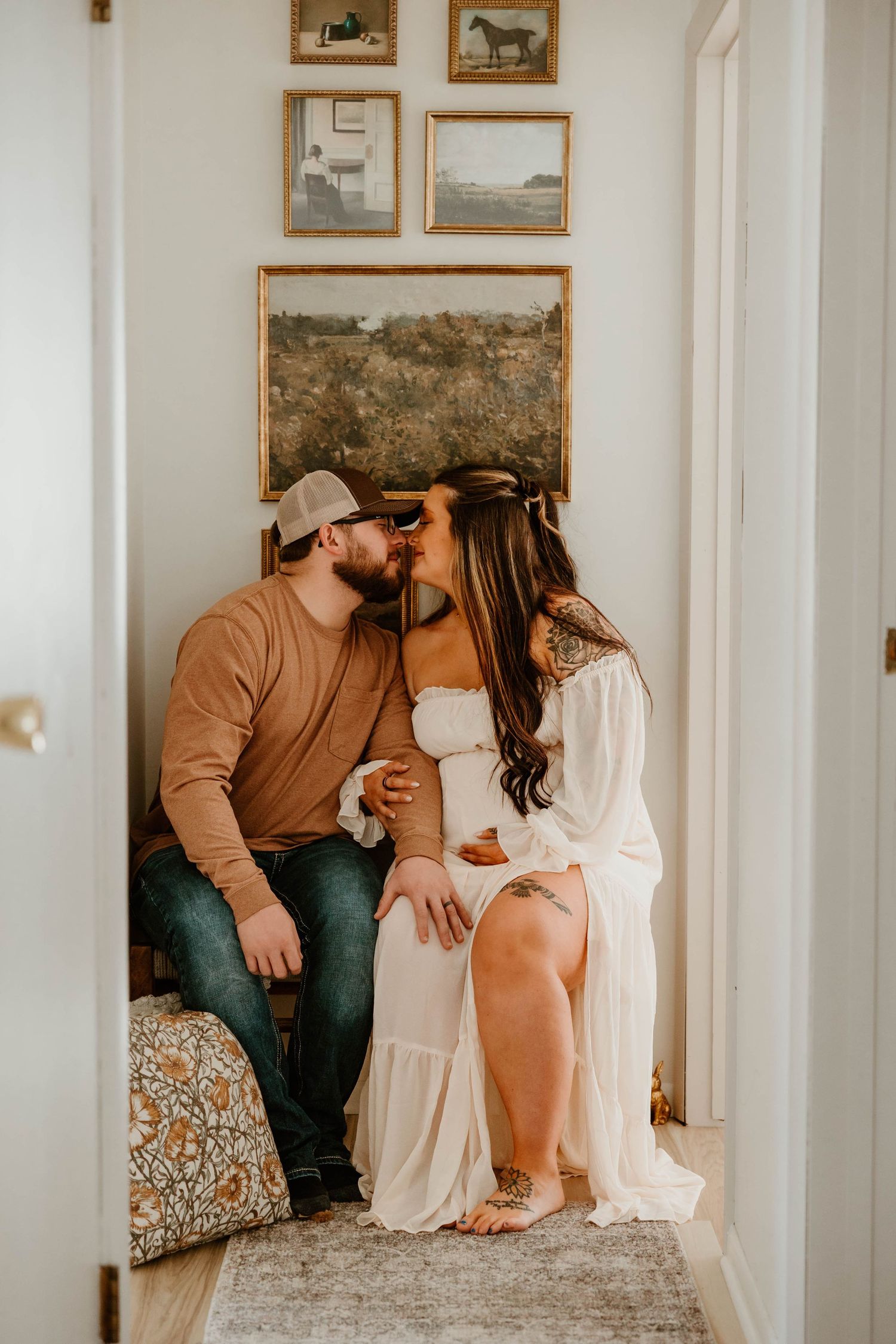 Intimate moment captured in hallway with vintage horse artwork on walls.