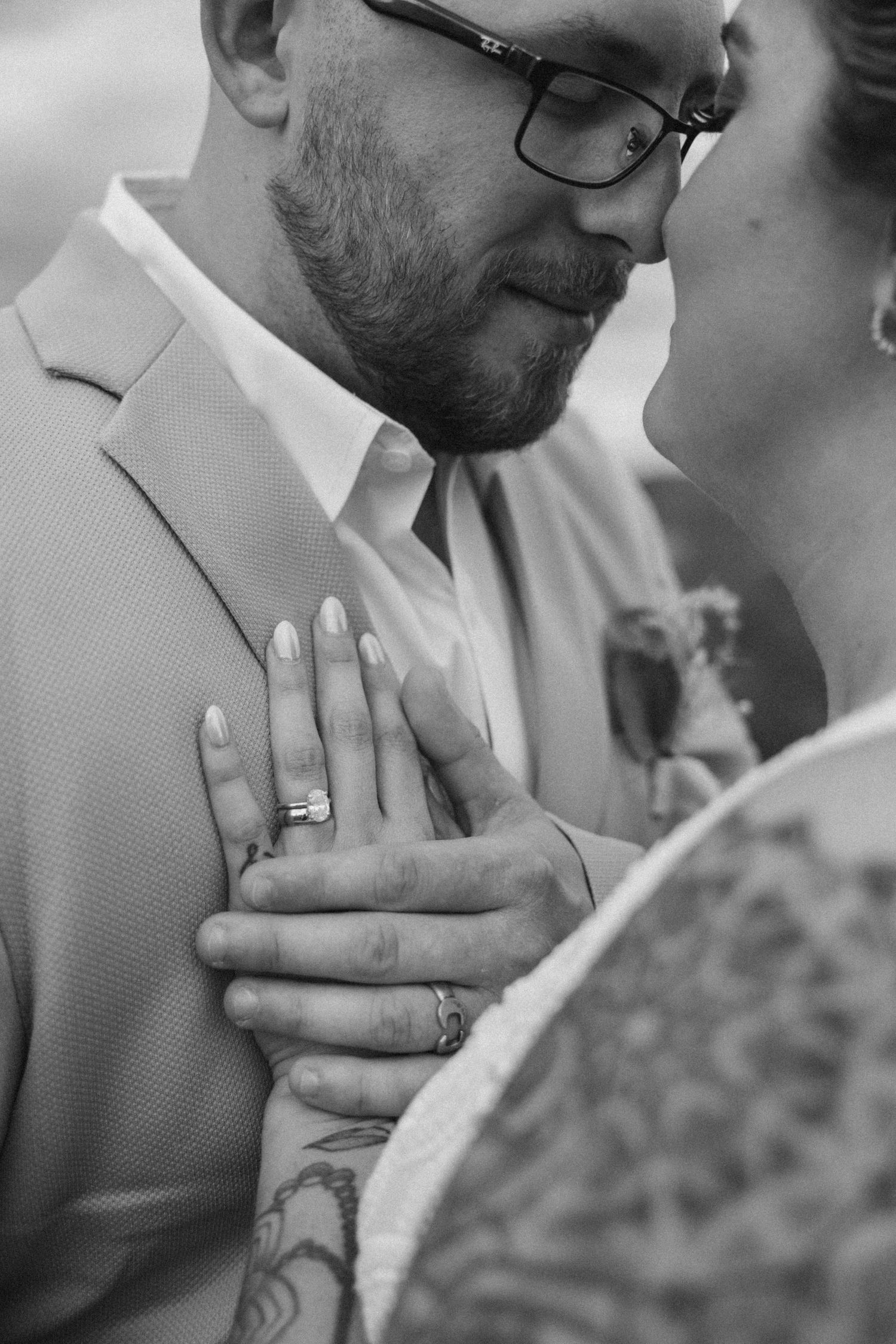 Black and white close-up sequence showing wedding rings and tender moments.