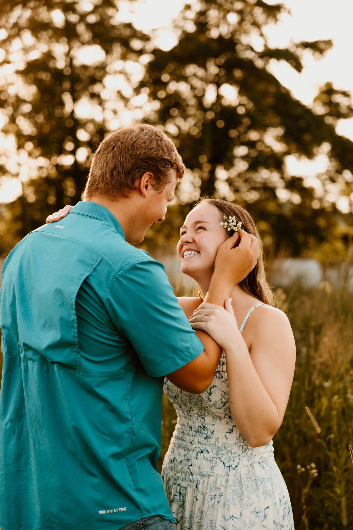 Intimate moment shared between couple in summer evening light.