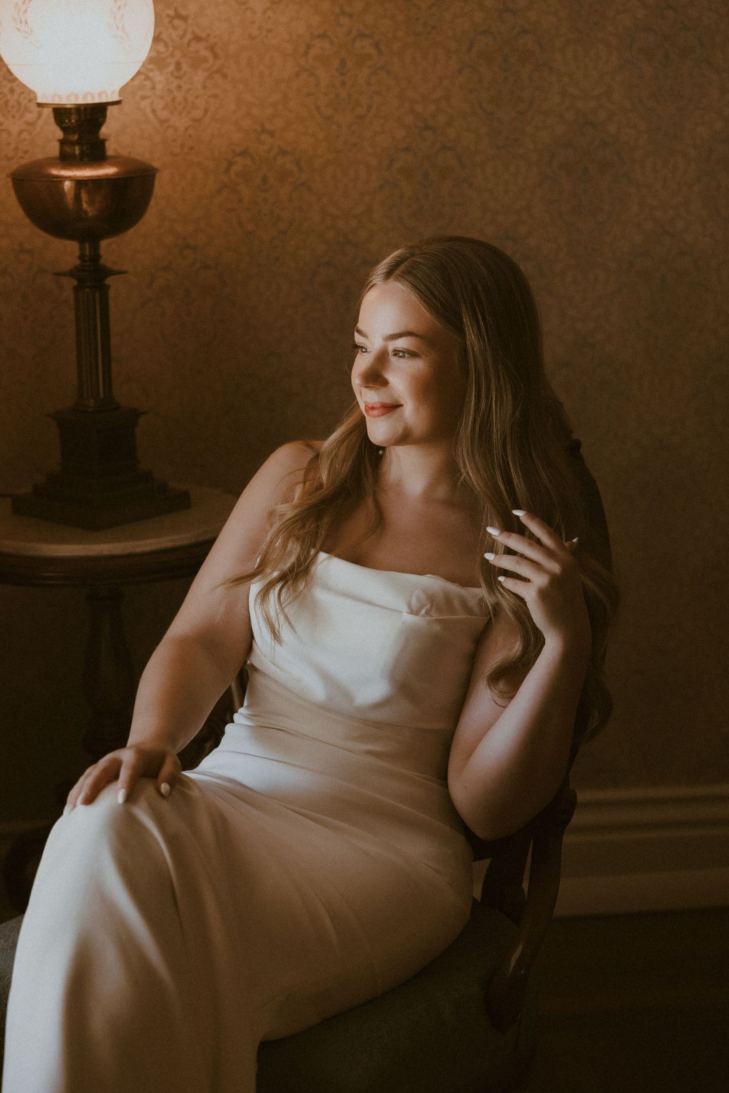 Artistic portrait in warm sepia tones with dramatic vintage lighting.