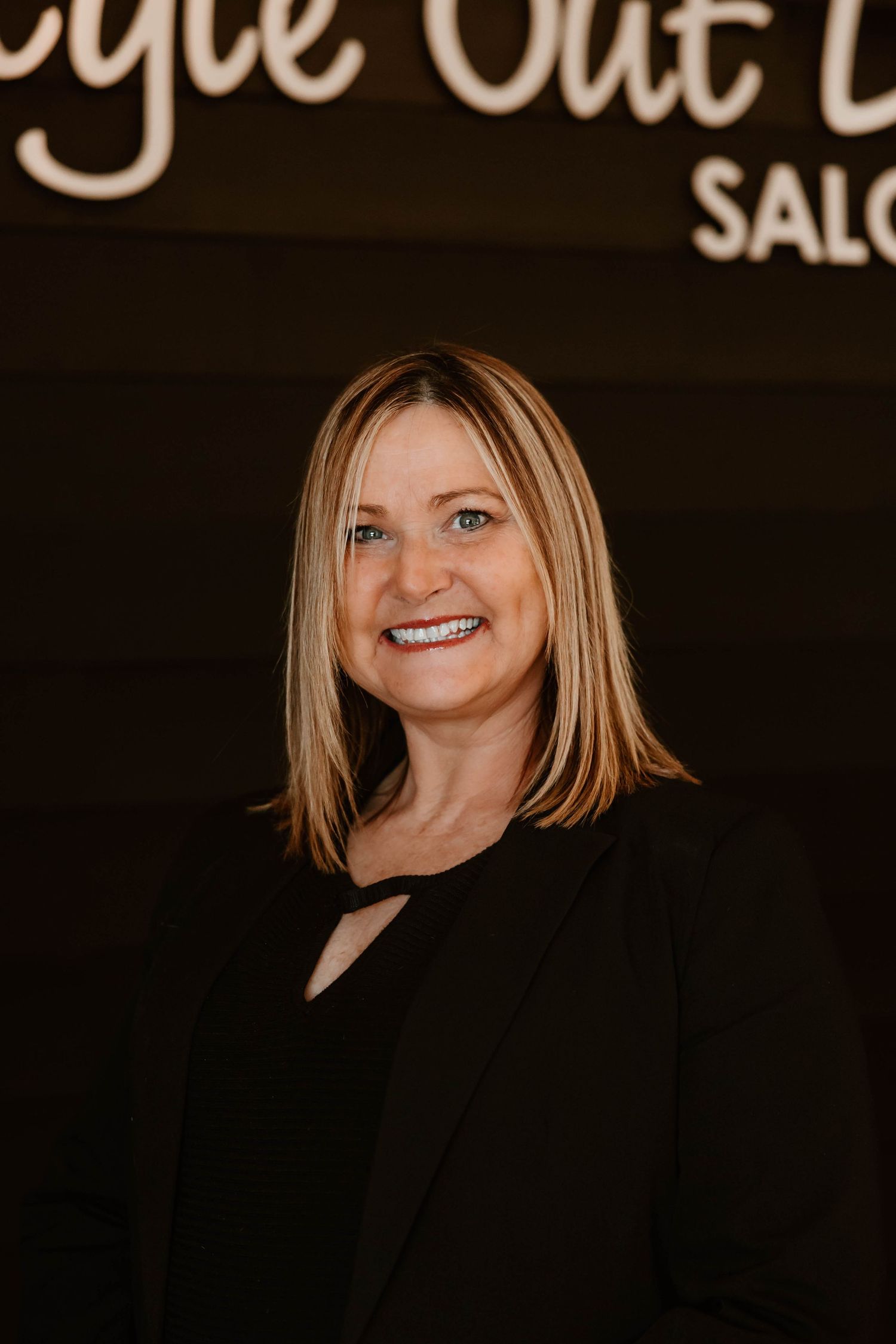 Elegant salon branding photo with 'Style Out Loud' text visible in background.