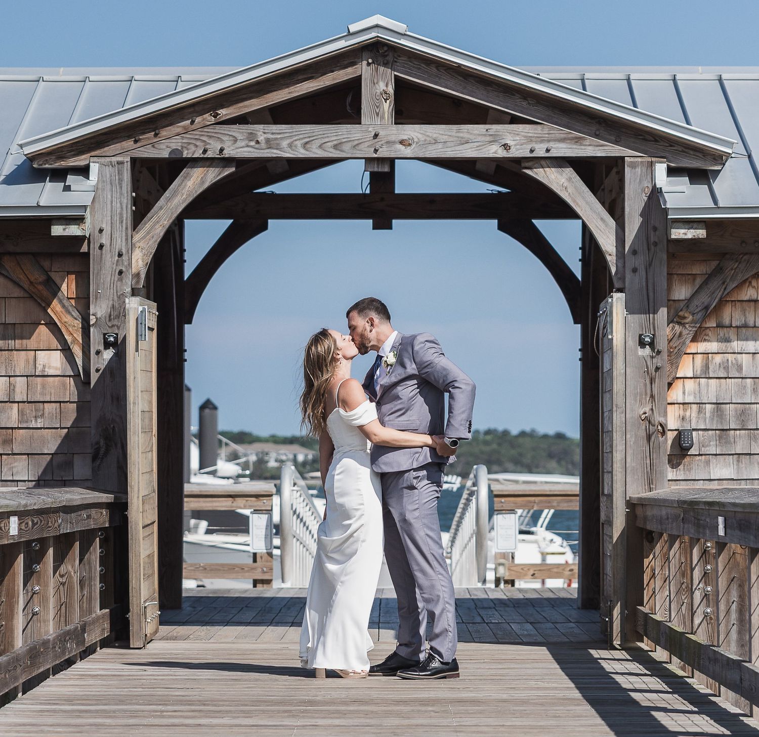 Bride and groom on their wedding day at the Charleston Marina locked in a warm embrace about to kiss.