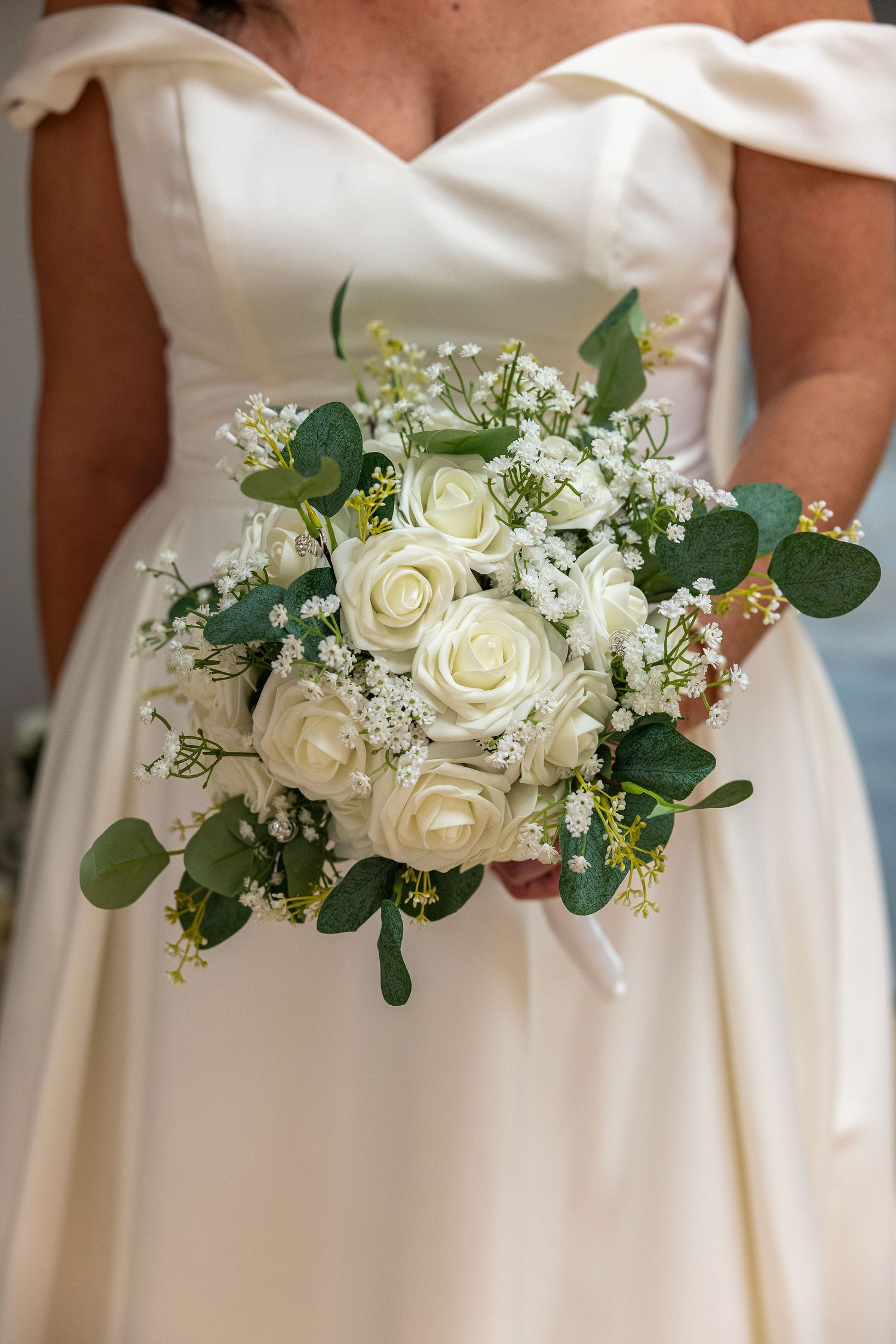 Bride in beautiful dress holding beautiful bouquet on the day of her wedding.