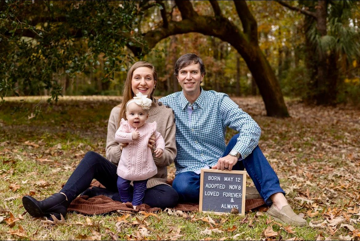 Celebrating a new born child and another one on the way. Fall leaves under a beautiful live oak in Charleston SC.