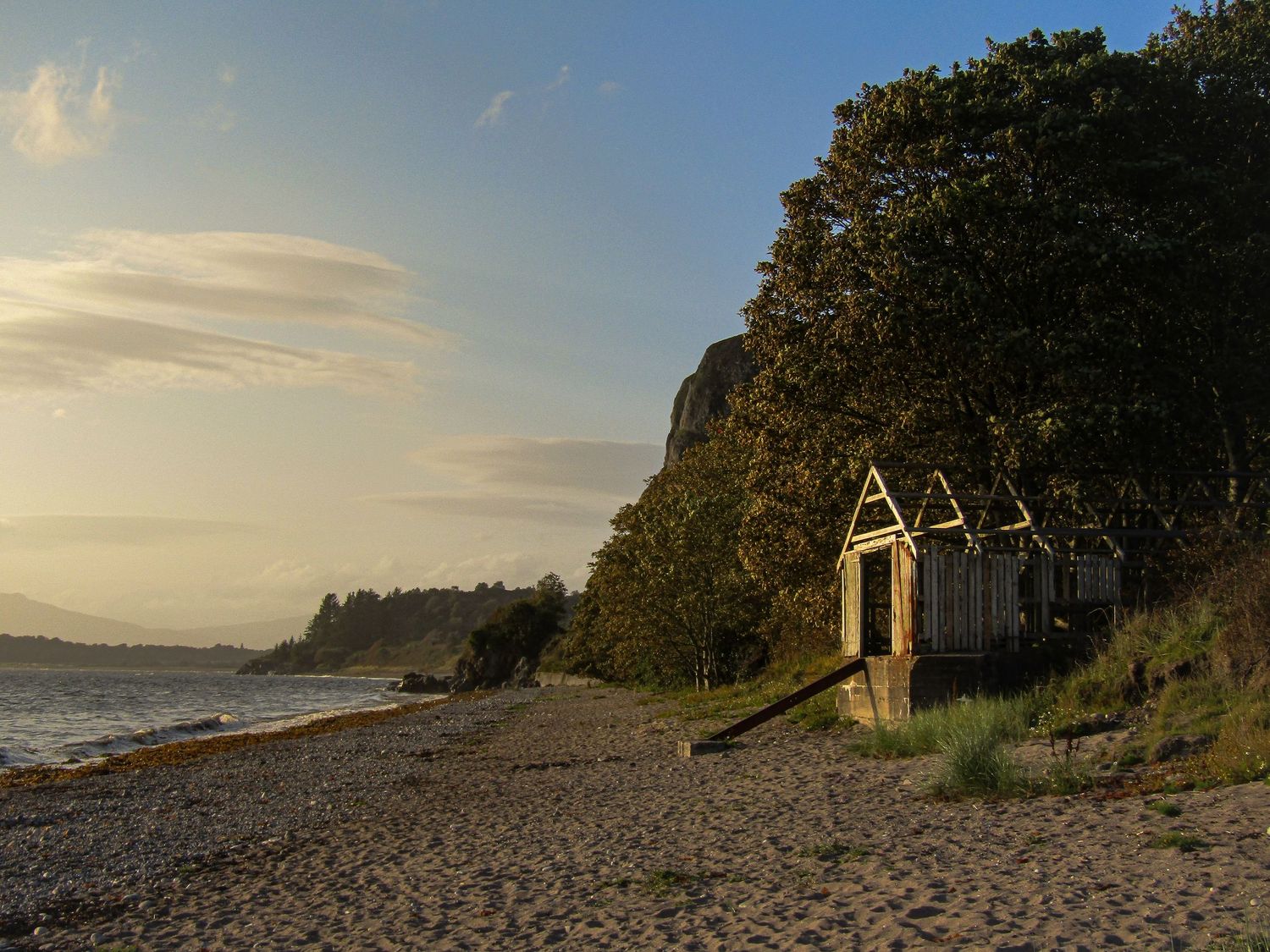 Fine art photo of boathouse on a sandy peddled shore at sunset, available as framed wall art prints and downloads.